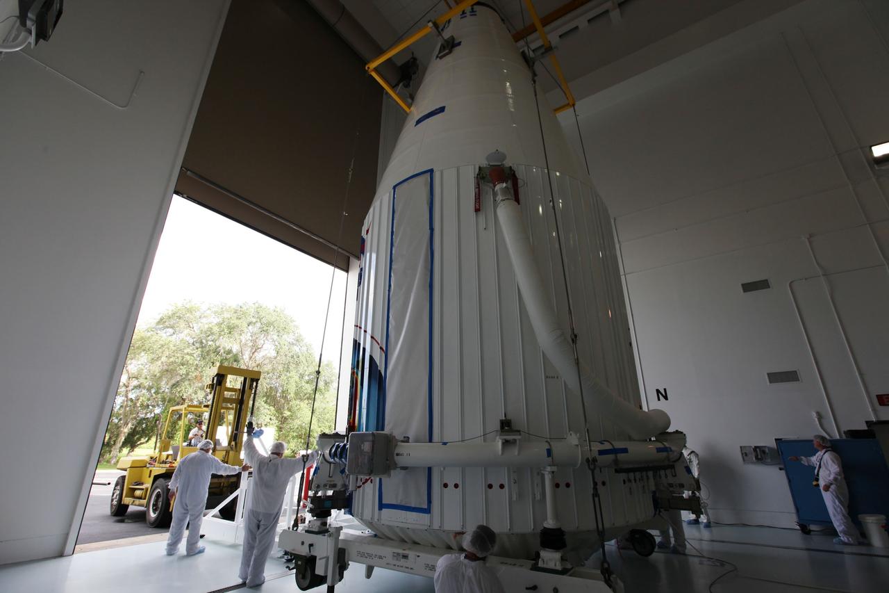 TITUSVILLE, Fla. - Inside the Astrotech payload processing facility in Titusville, Fla. near NASA’s Kennedy Space Center, technicians move the payload faring containing the two Radiation Belt Storm Probes, or RBSP, spacecraft into position for lifting on to a transporter to be moved to the launch complex. NASA’s RBSP mission will help us understand the sun’s influence on Earth and near-Earth space by studying the Earth’s radiation belts on various scales of space and time. RBSP will begin its mission of exploration of Earth’s Van Allen radiation belts and the extremes of space weather after its liftoff aboard a United Launch Alliance Atlas V rocket from Space Launch Complex 41 at Cape Canaveral Air Force Station, Fla. Liftoff is targeted for Aug. 23, 2012. For more information, visit http://www.nasa.gov/rbsp Photo credit: NASA/ Kim Shiflett