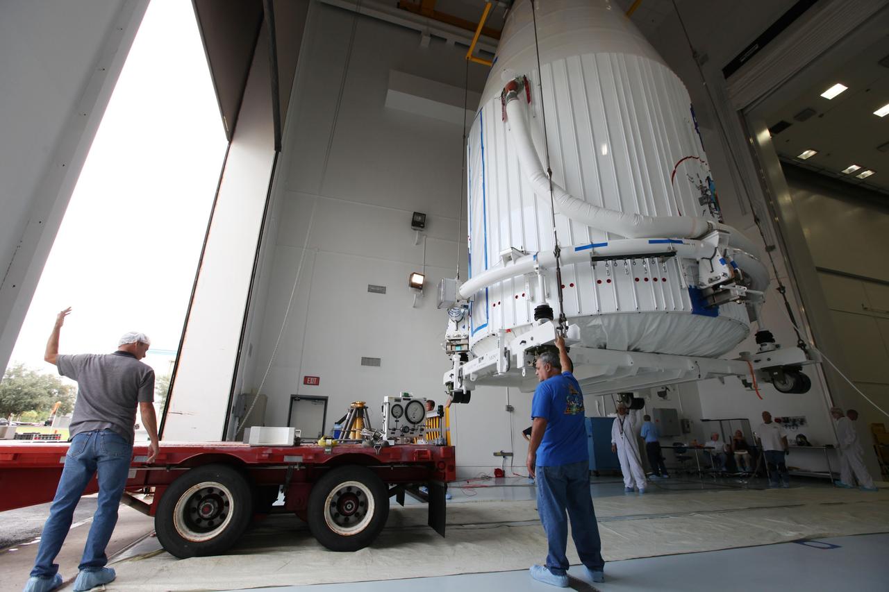 TITUSVILLE, Fla. - Inside the Astrotech payload processing facility in Titusville, Fla. near NASA’s Kennedy Space Center, technicians use a crane to lift the payload faring containing the two Radiation Belt Storm Probes, or RBSP, spacecraft as a transporter moves into position. NASA’s RBSP mission will help us understand the sun’s influence on Earth and near-Earth space by studying the Earth’s radiation belts on various scales of space and time. RBSP will begin its mission of exploration of Earth’s Van Allen radiation belts and the extremes of space weather after its liftoff aboard a United Launch Alliance Atlas V rocket from Space Launch Complex 41 at Cape Canaveral Air Force Station, Fla. Liftoff is targeted for Aug. 23, 2012. For more information, visit http://www.nasa.gov/rbsp Photo credit: NASA/ Kim Shiflett