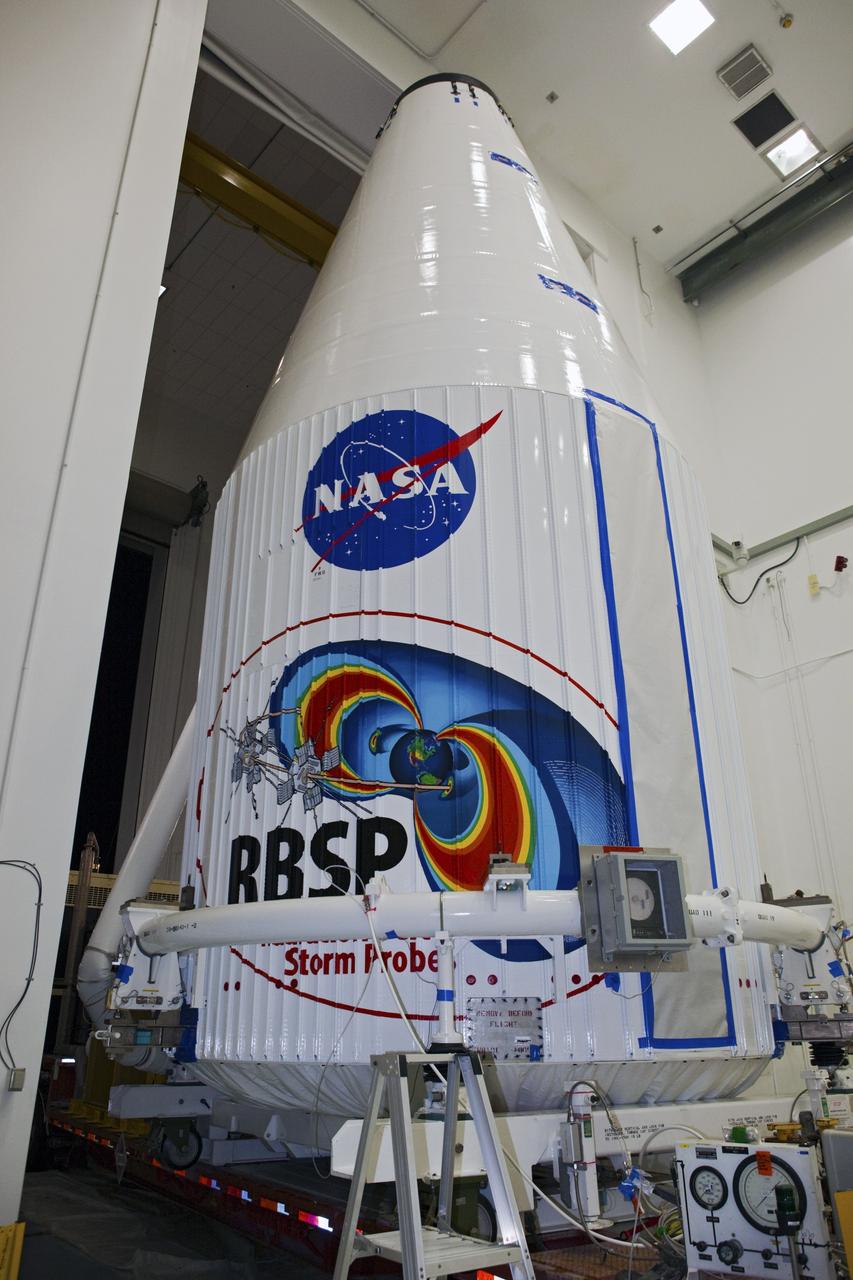 CAPE CANAVERAL, Fla. – The Radiation Belt Storm Probes, or RBSP, spacecraft are moved inside their payload fairing on the payload transporter from the Astrotech payload processing facility in Titusville, Fla. to Space Launch Complex-41 at Cape Canaveral Air Force Station. The fairing, which holds the twin RBSP spacecraft, will be lifted to the top of a United Launch Alliance Atlas V rocket for launch later in August. The two spacecraft are designed to study the Van Allen radiation belts in unprecedented detail. Photo credit: NASA/Dmitri Gerondidakis