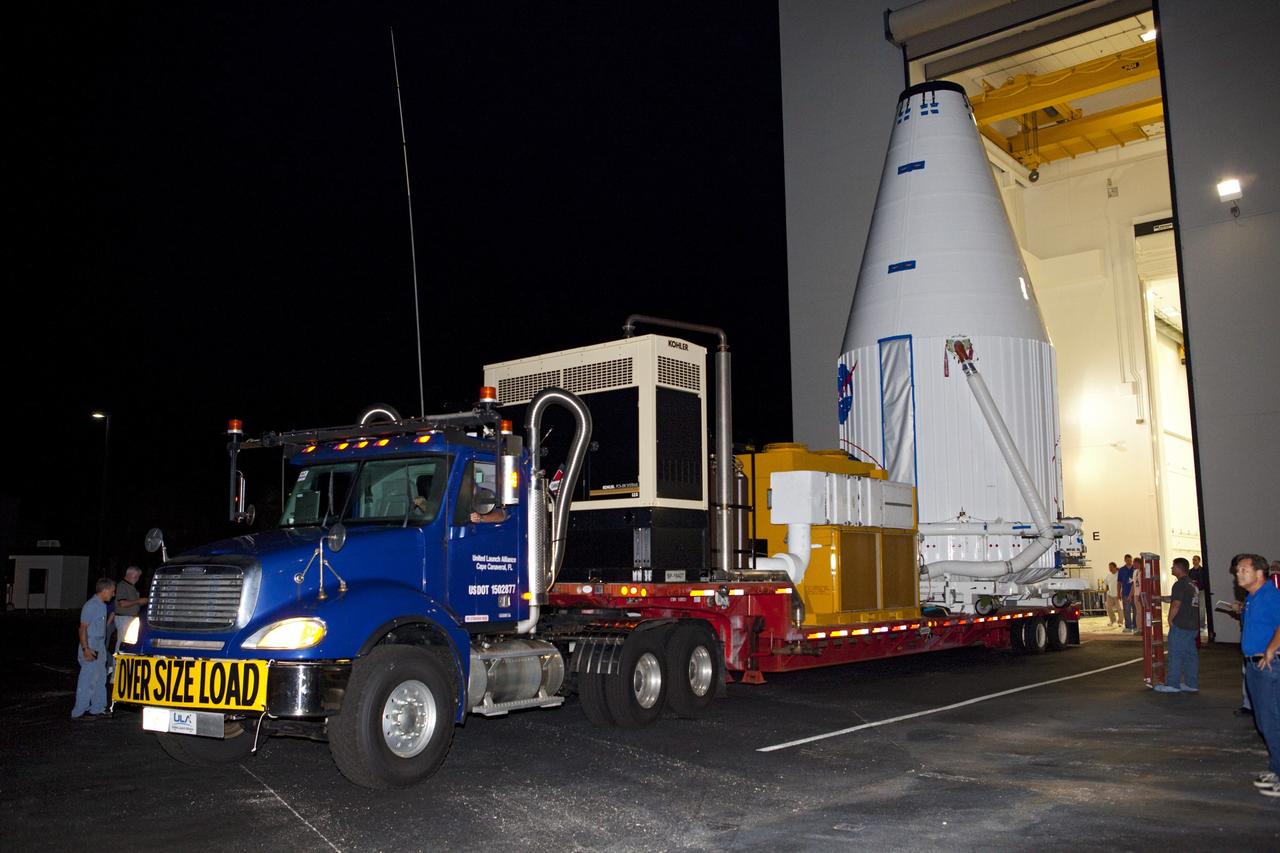 CAPE CANAVERAL, Fla. – The Radiation Belt Storm Probes, or RBSP, spacecraft are moved inside their payload fairing on the payload transporter from the Astrotech payload processing facility in Titusville, Fla. to Space Launch Complex-41 at Cape Canaveral Air Force Station. The fairing, which holds the twin RBSP spacecraft, will be lifted to the top of a United Launch Alliance Atlas V rocket for launch later in August. The two spacecraft are designed to study the Van Allen radiation belts in unprecedented detail. Photo credit: NASA/Dmitri Gerondidakis