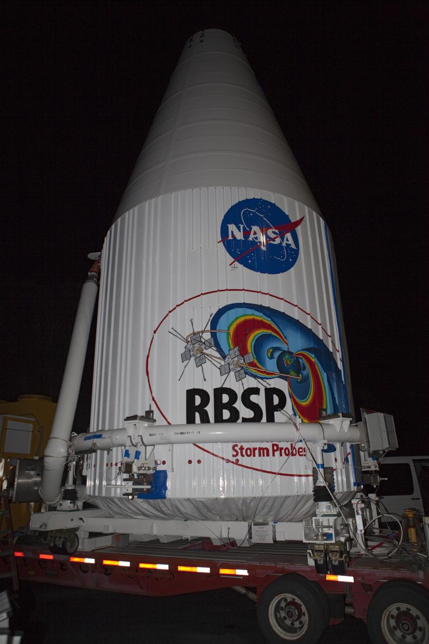 CAPE CANAVERAL, Fla. – The Radiation Belt Storm Probes, or RBSP, spacecraft are moved inside their payload fairing on the payload transporter from the Astrotech payload processing facility in Titusville, Fla. to Space Launch Complex-41 at Cape Canaveral Air Force Station. The fairing, which holds the twin RBSP spacecraft, will be lifted to the top of a United Launch Alliance Atlas V rocket for launch later in August. The two spacecraft are designed to study the Van Allen radiation belts in unprecedented detail. Photo credit: NASA/Dmitri Gerondidakis
