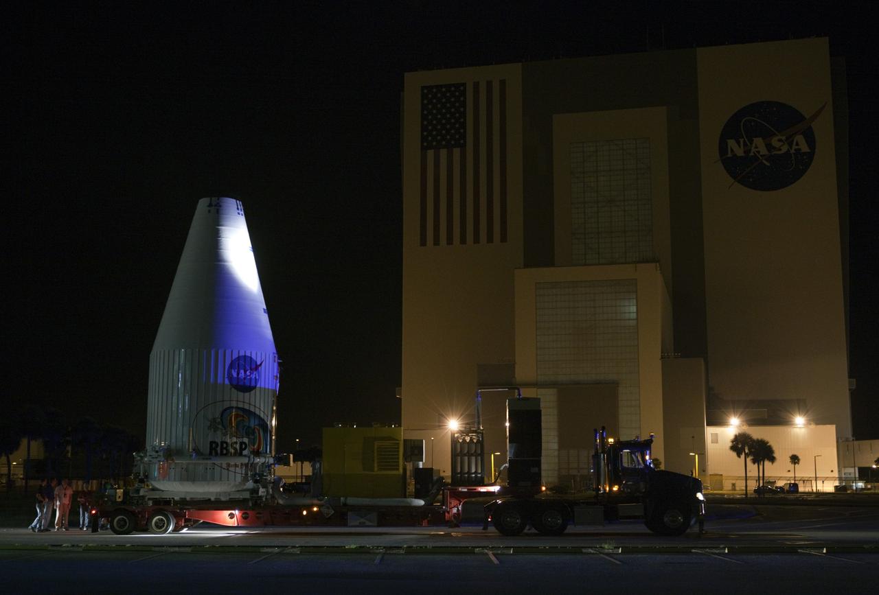CAPE CANAVERAL, Fla. – The Radiation Belt Storm Probes, or RBSP, spacecraft are moved inside their payload fairing on the payload transporter from the Astrotech payload processing facility in Titusville, Fla. to Space Launch Complex-41 at Cape Canaveral Air Force Station. The convoy carried the spacecraft past the Vehicle Assembly Building at NASA's Kennedy Space Center. The fairing, which holds the twin RBSP spacecraft, will be lifted to the top of a United Launch Alliance Atlas V rocket for launch later in August. The two spacecraft are designed to study the Van Allen radiation belts in unprecedented detail. Photo credit: NASA/Dmitri Gerondidakis