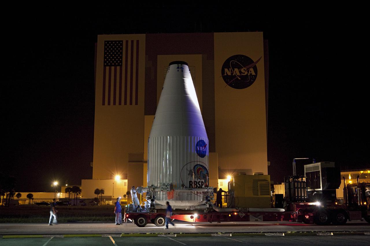 CAPE CANAVERAL, Fla. – The Radiation Belt Storm Probes, or RBSP, spacecraft are moved inside their payload fairing on the payload transporter from the Astrotech payload processing facility in Titusville, Fla. to Space Launch Complex-41 at Cape Canaveral Air Force Station. The convoy carried the spacecraft past the Vehicle Assembly Building at NASA's Kennedy Space Center. The fairing, which holds the twin RBSP spacecraft, will be lifted to the top of a United Launch Alliance Atlas V rocket for launch later in August. The two spacecraft are designed to study the Van Allen radiation belts in unprecedented detail. Photo credit: NASA/Dmitri Gerondidakis