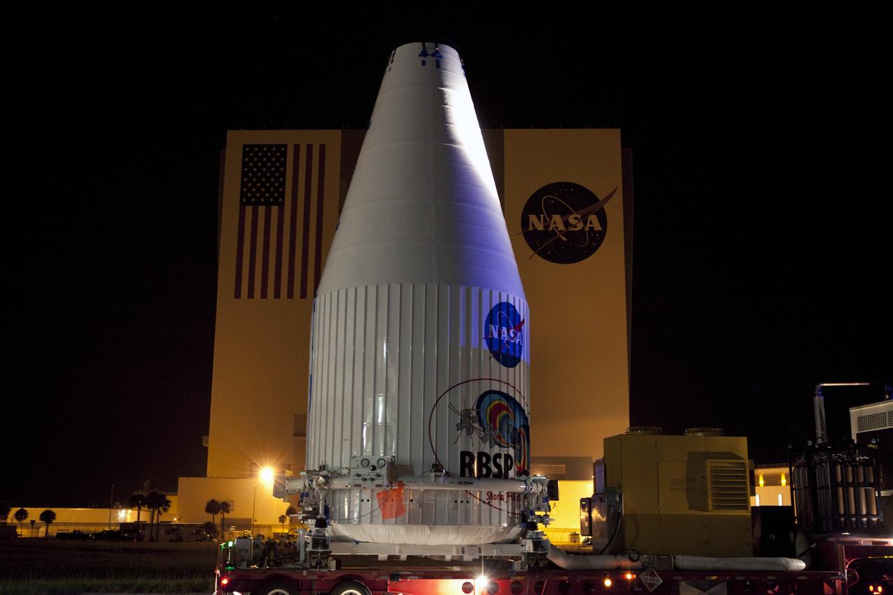CAPE CANAVERAL, Fla. – The Radiation Belt Storm Probes, or RBSP, spacecraft are moved inside their payload fairing on the payload transporter from the Astrotech payload processing facility in Titusville, Fla. to Space Launch Complex-41 at Cape Canaveral Air Force Station. The convoy carried the spacecraft past the Vehicle Assembly Building at NASA's Kennedy Space Center. The fairing, which holds the twin RBSP spacecraft, will be lifted to the top of a United Launch Alliance Atlas V rocket for launch later in August. The two spacecraft are designed to study the Van Allen radiation belts in unprecedented detail. Photo credit: NASA/Dmitri Gerondidakis