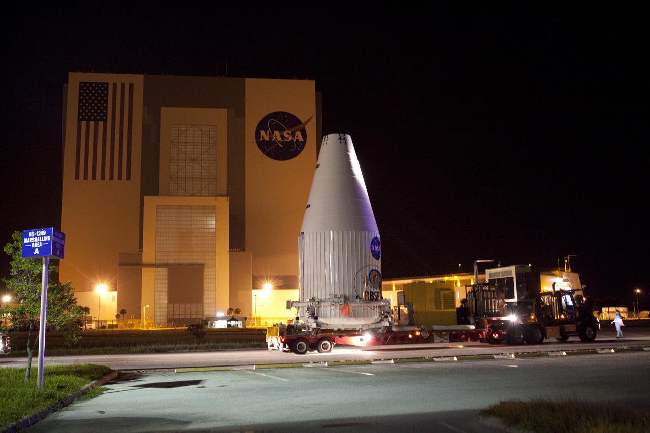 CAPE CANAVERAL, Fla. – The Radiation Belt Storm Probes, or RBSP, spacecraft are moved inside their payload fairing on the payload transporter from the Astrotech payload processing facility in Titusville, Fla. to Space Launch Complex-41 at Cape Canaveral Air Force Station. The convoy carried the spacecraft past the Vehicle Assembly Building at NASA's Kennedy Space Center. The fairing, which holds the twin RBSP spacecraft, will be lifted to the top of a United Launch Alliance Atlas V rocket for launch later in August. The two spacecraft are designed to study the Van Allen radiation belts in unprecedented detail. Photo credit: NASA/Dmitri Gerondidakis