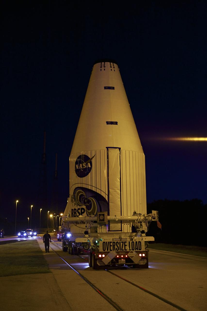 CAPE CANAVERAL, Fla. – The Radiation Belt Storm Probes, or RBSP, spacecraft are moved inside their payload fairing on the payload transporter from the Astrotech payload processing facility in Titusville, Fla. to Space Launch Complex-41 at Cape Canaveral Air Force Station. The fairing, which holds the twin RBSP spacecraft, will be lifted to the top of a United Launch Alliance Atlas V rocket for launch later in August. The two spacecraft are designed to study the Van Allen radiation belts in unprecedented detail. Photo credit: NASA/Dmitri Gerondidakis