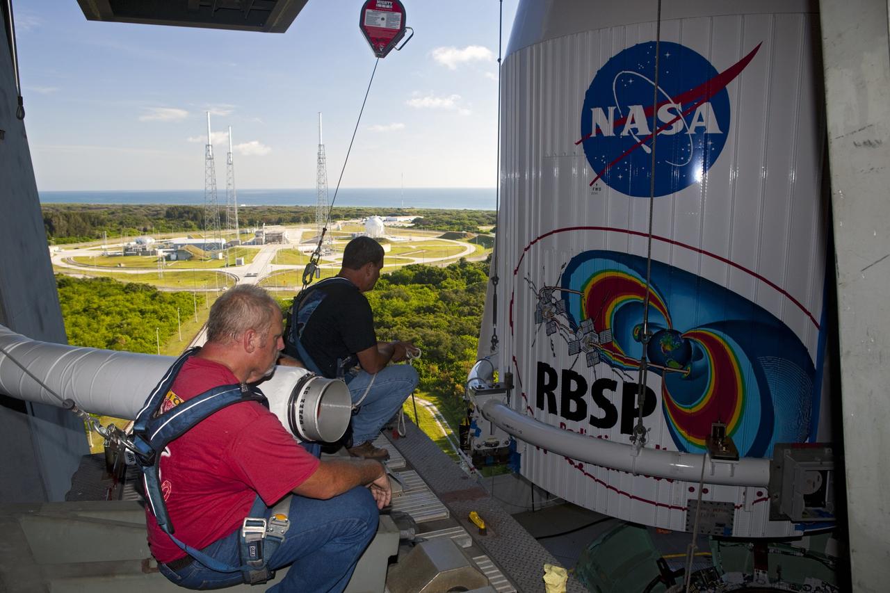CAPE CANAVERAL, Fla. – Technicians attach the payload fairing holding the Radiation Belt Storm Probes, or RBSP, spacecraft to the top of a United Launch Alliance Atlas V rocket at Space Launch Complex-41 at Cape Canaveral Air Force Station. The two spacecraft are designed to study the Van Allen radiation belts in unprecedented detail. Photo credit: NASA/Dmitri Gerondidakis