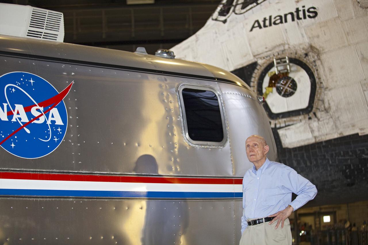CAPE CANAVERAL, Fla. – Lt. Gen. Thomas P. Stafford, former astronaut and Air Force test pilot, stands near the Astrovan and space shuttle Atlantis inside the Vehicle Assembly Building at NASA's Kennedy Space Center in Florida. Stafford flew two Gemini missions, commanded Apollo 10 and commanded the Apollo-Soyuz test mission during his NASA career. Photo credit: NASA/Frankie Martin