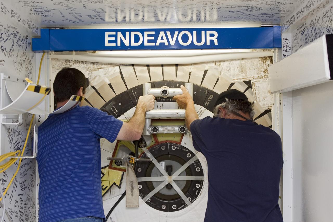 CAPE CANAVERAL, Fla. – In Orbiter Processing Facility Bay 2 at NASA’s Kennedy Space Center in Florida, United Space Alliance technicians Gary Hamilton, left, and Joe Walsh close the space shuttle Endeavour's hatch. The orbiter is undergoing final preparations for its cross-country ferry flight to California. The work is part of Transition and Retirement of the remaining space shuttles, Endeavour and Atlantis. Endeavour is being prepared for public display at the California Science Center in Los Angeles. Its ferry flight to California is targeted for mid-September. Endeavour was the last space shuttle added to NASA’s orbiter fleet. Over the course of its 19-year career, Endeavour spent 299 days in space during 25 missions. For more information, visit http://www.nasa.gov/transition Photo credit: NASA/ Jim Grossmann