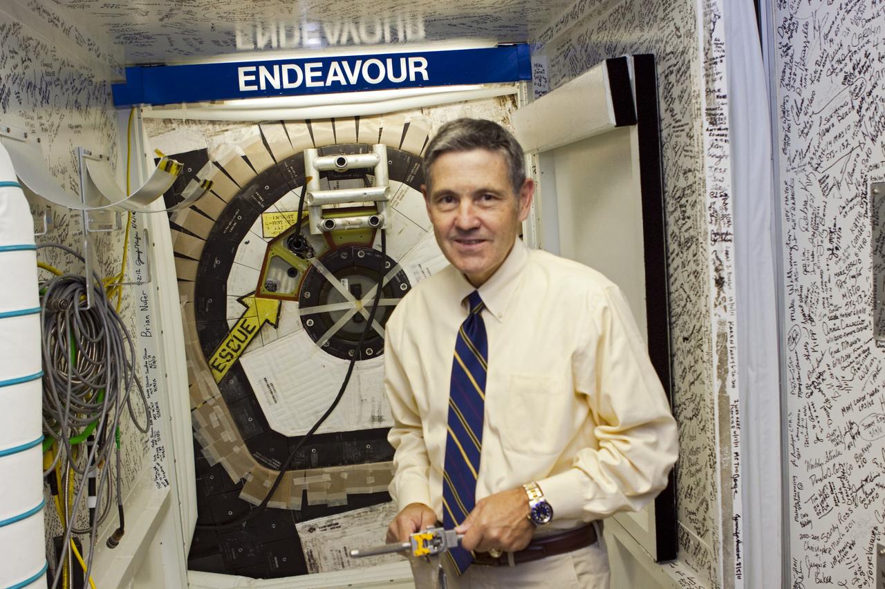 CAPE CANAVERAL, Fla. – In Orbiter Processing Facility Bay 2 at NASA’s Kennedy Space Center in Florida, Kennedy Space Center Director Bob Cabana holds the "T"-shaped tool he used to lock the space shuttle Endeavour's hatch. The orbiter is undergoing final preparations for its cross-country ferry flight to California. The work is part of Transition and Retirement of the remaining space shuttles, Endeavour and Atlantis. Endeavour is being prepared for public display at the California Science Center in Los Angeles. Its ferry flight to California is targeted for mid-September. Endeavour was the last space shuttle added to NASA’s orbiter fleet. Over the course of its 19-year career, Endeavour spent 299 days in space during 25 missions. For more information, visit http://www.nasa.gov/transition Photo credit: NASA/ Jim Grossmann