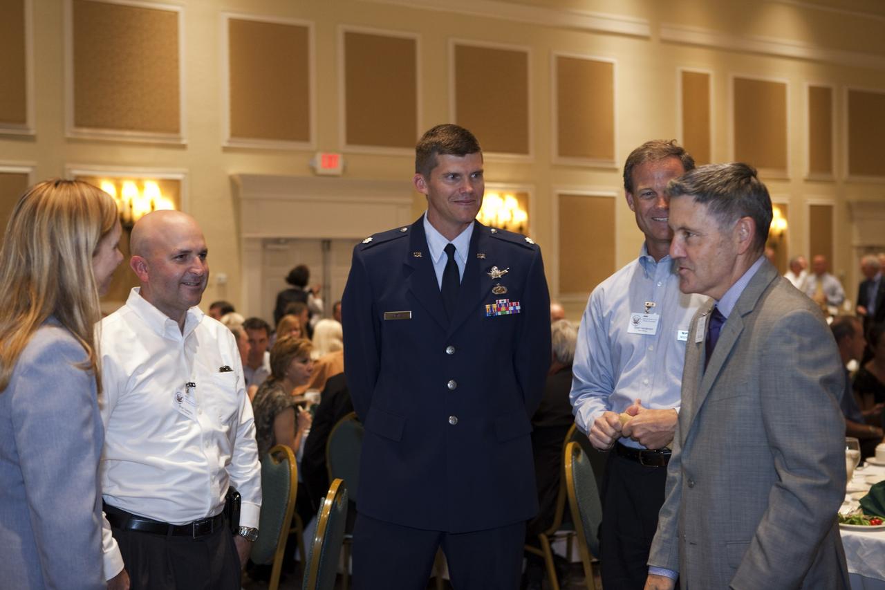 CAPE CANAVERAL, Fla. -- NASA Kennedy Space Center Director Bob Cabana, right, and Kennedy Deputy Director Janet Petro, left, talk with aerospace industry representatives during the National Space Club Florida Committee's August luncheon at the Radisson Resort at the Port in Cape Canaveral, Fla. NASA Commercial Crew Program Manager Ed Mango was the event's guest speaker, discussing the innovative steps the agency is taking with industry partners to develop the next U.S. space transportation capability to and from low Earth orbit, which will eventually be available for use by the U.S. government and other commercial customers. To learn more about the Commercial Crew Program, visit www.nasa.gov/commercialcrew. Photo credit: Kim Shiflett
