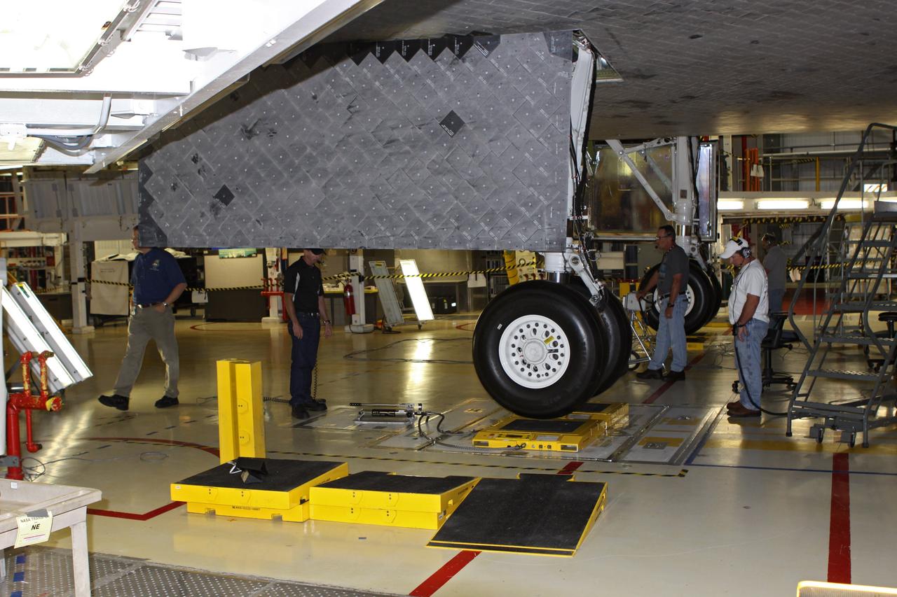 CAPE CANAVERAL, Fla. – In Orbiter Processing Facility Bay 2 at NASA’s Kennedy Space Center in Florida, United Space Alliance technicians complete weight and center of gravity checks on the space shuttle Endeavour. The work is part of Transition and Retirement of the remaining space shuttles, Endeavour and Atlantis. Endeavour is being prepared for public display at the California Science Center in Los Angeles. Its ferry flight to California is targeted for mid-September. Endeavour was the last space shuttle added to NASA’s orbiter fleet. Over the course of its 19-year career, Endeavour spent 299 days in space during 25 missions. For more information, visit http://www.nasa.gov/transition Photo credit: NASA/ Jim Grossmann