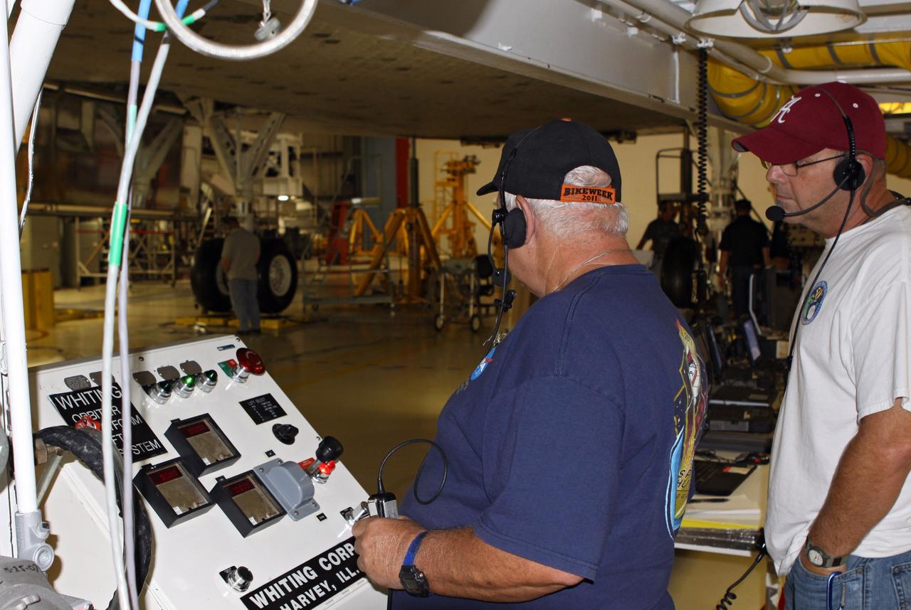 CAPE CANAVERAL, Fla. – In Orbiter Processing Facility Bay 2 at NASA’s Kennedy Space Center in Florida, United Space Alliance USA aerospace technician Jim Reed and USA aerospace quality assurance inspector Rob Lewis complete weight and center of gravity checks on the space shuttle Endeavour. The work is part of Transition and Retirement of the remaining space shuttles, Endeavour and Atlantis. Endeavour is being prepared for public display at the California Science Center in Los Angeles. Its ferry flight to California is targeted for mid-September. Endeavour was the last space shuttle added to NASA’s orbiter fleet. Over the course of its 19-year career, Endeavour spent 299 days in space during 25 missions. For more information, visit http://www.nasa.gov/transition Photo credit: NASA/ Jim Grossmann