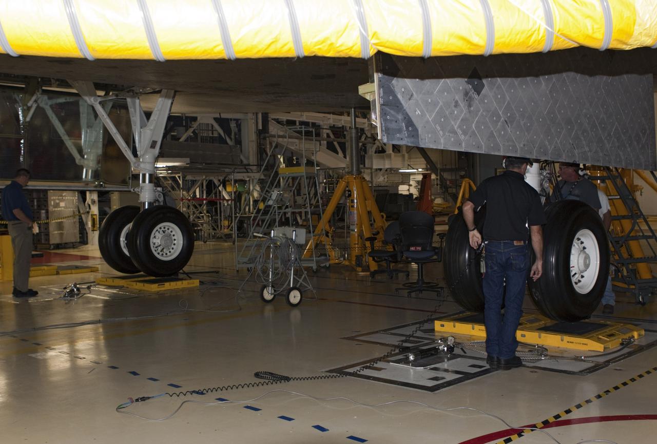 CAPE CANAVERAL, Fla. – In Orbiter Processing Facility Bay 2 at NASA’s Kennedy Space Center in Florida, United Space Alliance technicians complete weight and center of gravity checks on the space shuttle Endeavour. The work is part of Transition and Retirement of the remaining space shuttles, Endeavour and Atlantis. Endeavour is being prepared for public display at the California Science Center in Los Angeles. Its ferry flight to California is targeted for mid-September. Endeavour was the last space shuttle added to NASA’s orbiter fleet. Over the course of its 19-year career, Endeavour spent 299 days in space during 25 missions. For more information, visit http://www.nasa.gov/transition Photo credit: NASA/ Jim Grossmann