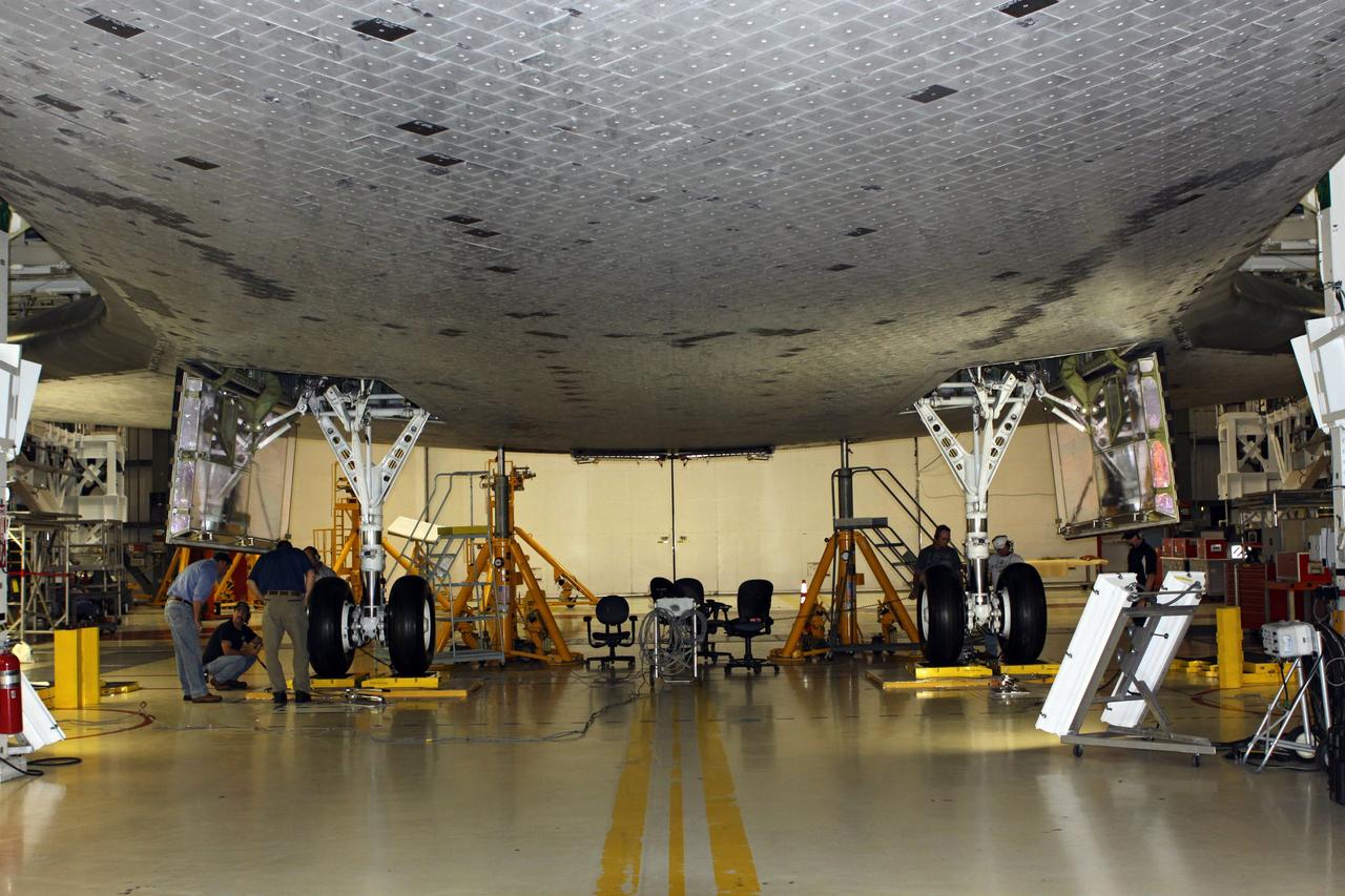 CAPE CANAVERAL, Fla. – Looking along the under belly of the space shuttle Endeavour toward its main landing gear, United Space Alliance technicians complete weight and center of gravity checks in Bay 2 of the Orbiter Processing Facility at NASA’s Kennedy Space Center in Florida.      The work is part of Transition and Retirement of the remaining space shuttles, Endeavour and Atlantis. Endeavour is being prepared for public display at the California Science Center in Los Angeles. Its ferry flight to California is targeted for mid-September. Endeavour was the last space shuttle added to NASA’s orbiter fleet. Over the course of its 19-year career, Endeavour spent 299 days in space during 25 missions. For more information, visit http://www.nasa.gov/transition Photo credit: NASA/ Jim Grossmann