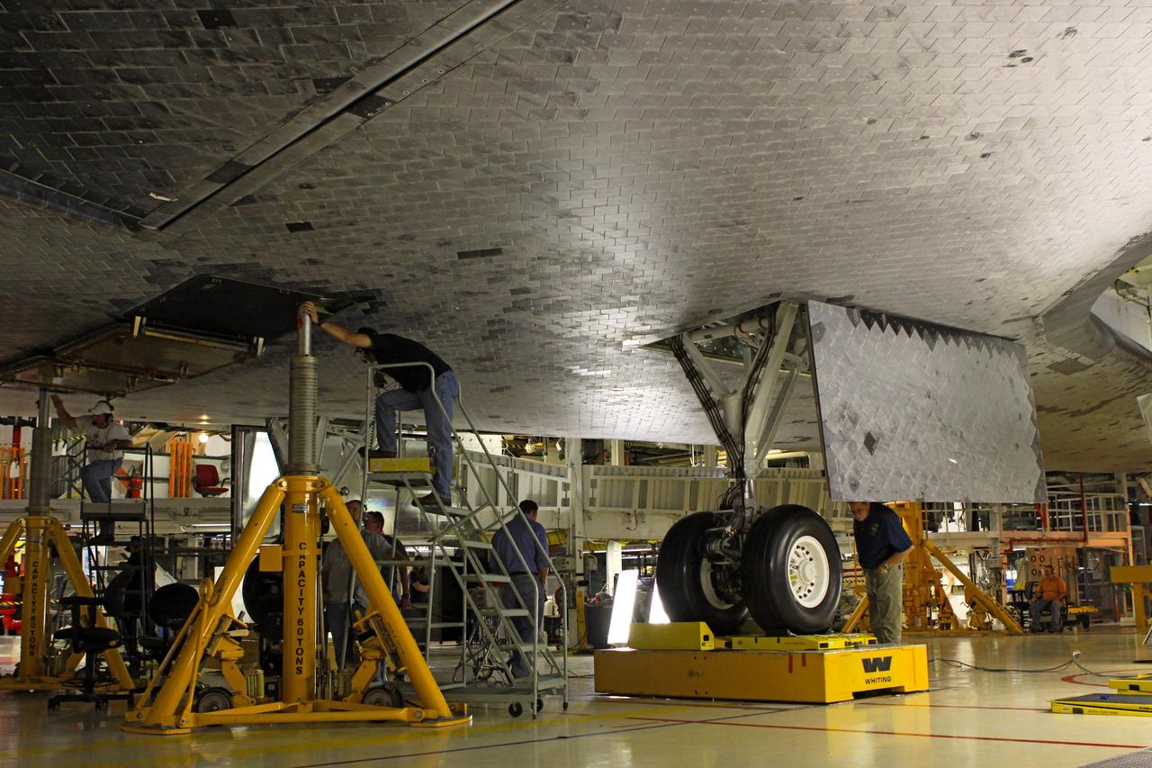 CAPE CANAVERAL, Fla. – Looking along the under belly toward the main landing gear of the space shuttle Endeavour, United Space Alliance technicians complete weight and center of gravity checks in Bay 2 of the Orbiter Processing Facility at NASA’s Kennedy Space Center in Florida.      The work is part of Transition and Retirement of the remaining space shuttles, Endeavour and Atlantis. Endeavour is being prepared for public display at the California Science Center in Los Angeles. Its ferry flight to California is targeted for mid-September. Endeavour was the last space shuttle added to NASA’s orbiter fleet. Over the course of its 19-year career, Endeavour spent 299 days in space during 25 missions. For more information, visit http://www.nasa.gov/transition Photo credit: NASA/ Jim Grossmann