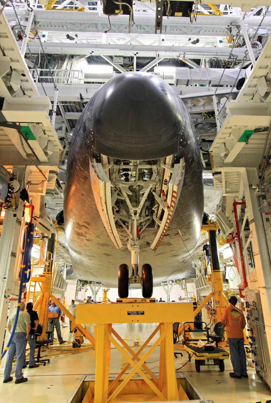 CAPE CANAVERAL, Fla. – Looking along the nose landing gear of the space shuttle Endeavour, United Space Alliance technicians complete weight and center of gravity checks in Bay 2 of the Orbiter Processing Facility at NASA’s Kennedy Space Center in Florida.      The work is part of Transition and Retirement of the remaining space shuttles, Endeavour and Atlantis. Endeavour is being prepared for public display at the California Science Center in Los Angeles. Its ferry flight to California is targeted for mid-September. Endeavour was the last space shuttle added to NASA’s orbiter fleet. Over the course of its 19-year career, Endeavour spent 299 days in space during 25 missions. For more information, visit http://www.nasa.gov/transition Photo credit: NASA/ Jim Grossmann