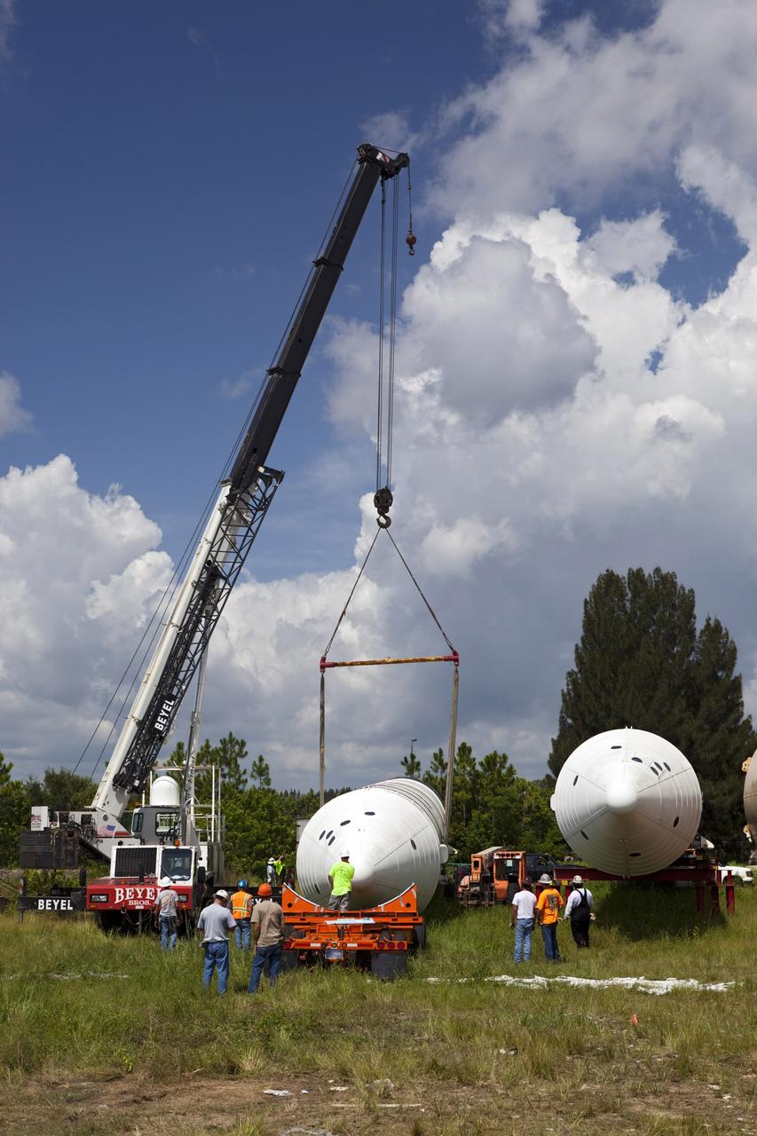 CAPE CANAVERAL, Fla. – At NASA’s Kennedy Space Center in Florida, a crane is used to load a twin set of space shuttle solid rocket boosters on trucks for transport to California. The solid rocket boosters, or SRBs, will be displayed at the California Science Center in Los Angeles. The 149-foot SRBs together provided six million pounds of thrust. The work is part of Transition and Retirement of the space shuttle. For more information, visit http://www.nasa.gov/transition Photo credit: NASA/ Dimitri Gerondidakis