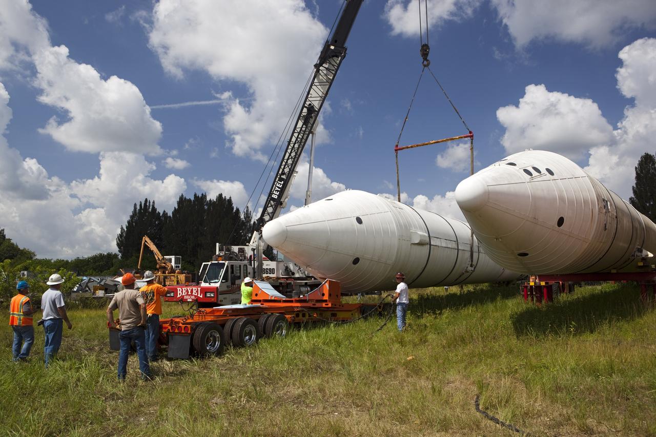 CAPE CANAVERAL, Fla. – At NASA’s Kennedy Space Center in Florida, a crane is used to load a twin set of space shuttle solid rocket boosters on trucks for transport to California. The solid rocket boosters, or SRBs, will be displayed at the California Science Center in Los Angeles. The 149-foot SRBs together provided six million pounds of thrust. The work is part of Transition and Retirement of the space shuttle. For more information, visit http://www.nasa.gov/transition Photo credit: NASA/ Dimitri Gerondidakis