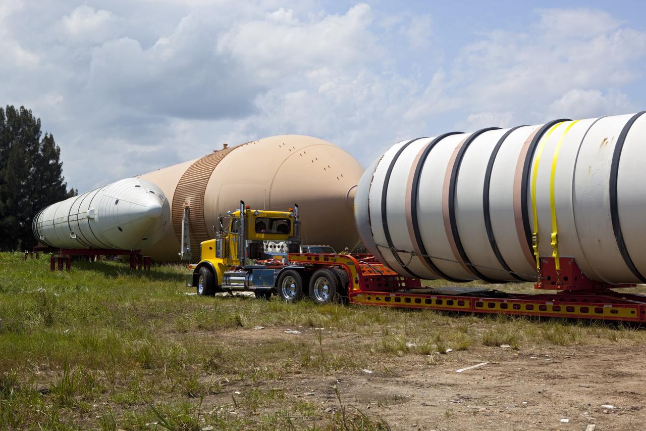 CAPE CANAVERAL, Fla. – At NASA’s Kennedy Space Center in Florida, a twin set of space shuttle solid rocket boosters and an external fuel tank are being loaded on trucks for transport to separate museums.      The solid rocket boosters, or SRBs, will be displayed at the California Science Center in Los Angeles. The external tank soon will be transported for display at the Wings of Dreams Aviation Museum at Keystone Heights Airport between Gainesville and Jacksonville, Fla. The 149-foot SRBs together provided six million pounds of thrust. The external fuel tank contained over 500,000 gallons of liquid hydrogen and liquid oxygen propellant for the shuttle orbiters' three main engines. The work is part of Transition and Retirement of the space shuttle. For more information, visit http://www.nasa.gov/transition Photo credit: NASA/ Dimitri Gerondidakis