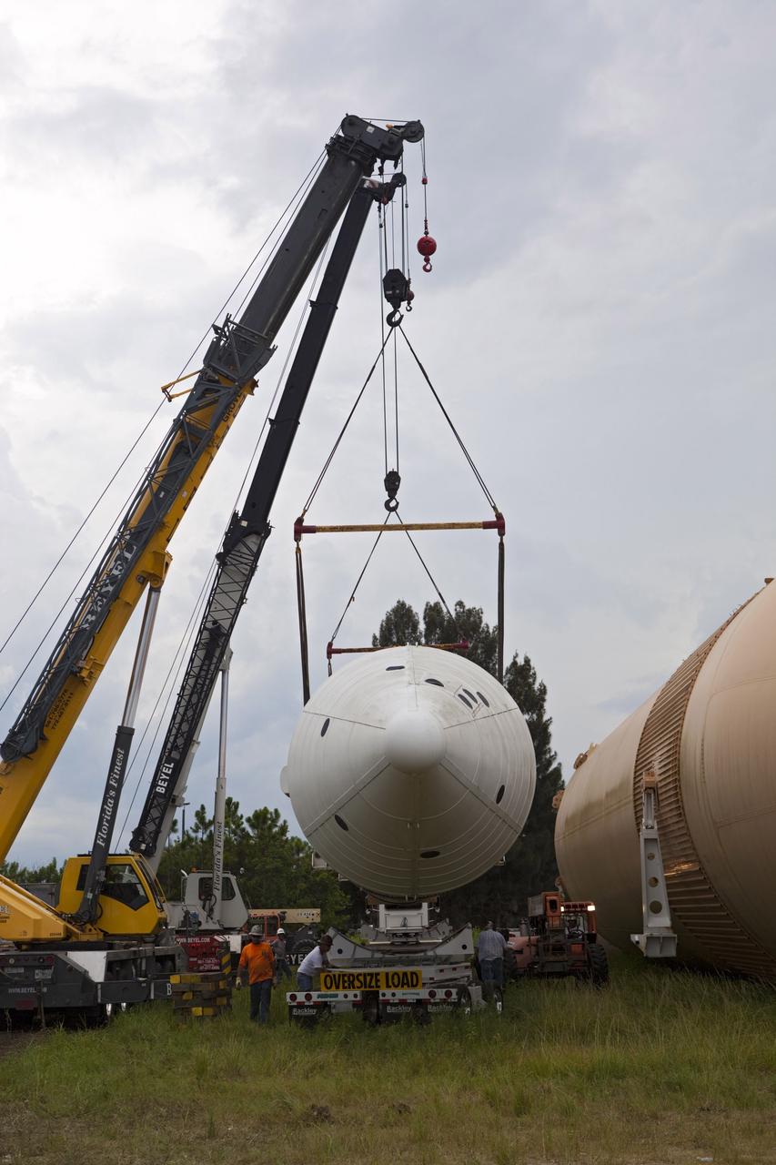 CAPE CANAVERAL, Fla. – At NASA’s Kennedy Space Center in Florida, a crane is used to load a space shuttle solid rocket booster and an external fuel tank on trucks for transport to separate museums.    The solid rocket boosters, or SRBs, will be displayed at the California Science Center in Los Angeles. The external tank soon will be transported for display at the Wings of Dreams Aviation Museum at Keystone Heights Airport between Gainesville and Jacksonville, Fla. The 149-foot SRBs together provided six million pounds of thrust. The external fuel tank contained over 500,000 gallons of liquid hydrogen and liquid oxygen propellant for the shuttle orbiters' three main engines. The work is part of Transition and Retirement of the space shuttle. For more information, visit http://www.nasa.gov/transition Photo credit: NASA/ Dimitri Gerondidakis