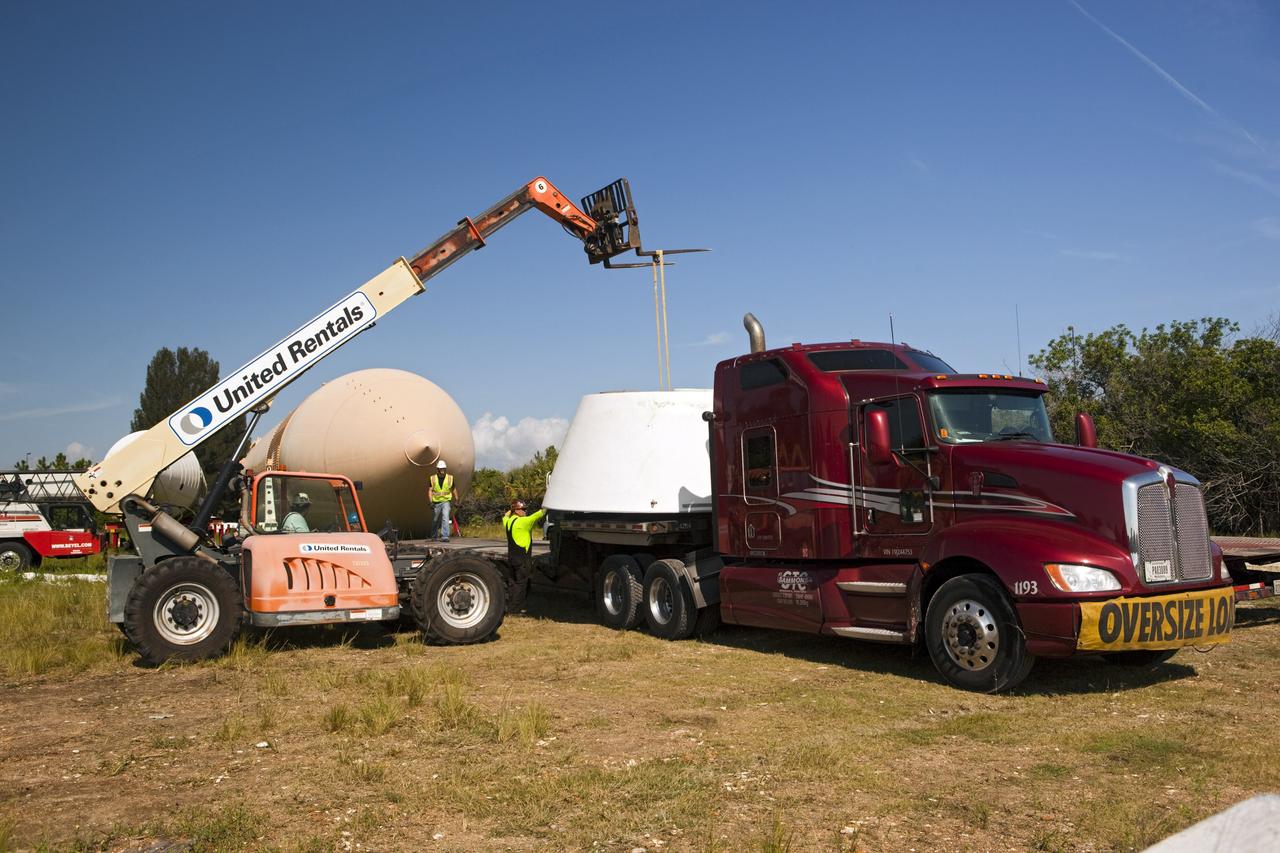 CAPE CANAVERAL, Fla. – At NASA’s Kennedy Space Center in Florida, a crane is used to load the aft skirt for a space shuttle solid rocket booster on a truck. A twin set of space shuttle solid rocket boosters and an external fuel tank are being prepared for transport to separate museums. The solid rocket boosters, or SRBs, will be displayed at the California Science Center in Los Angeles. The external tank soon will be transported for display at the Wings of Dreams Aviation Museum at Keystone Heights Airport between Gainesville and Jacksonville, Fla. The 149-foot SRBs together provided six million pounds of thrust. The external fuel tank contained over 500,000 gallons of liquid hydrogen and liquid oxygen propellant for the shuttle orbiters' three main engines. The work is part of Transition and Retirement of the space shuttle. For more information, visit http://www.nasa.gov/transition Photo credit: NASA/ Dimitri Gerondidakis