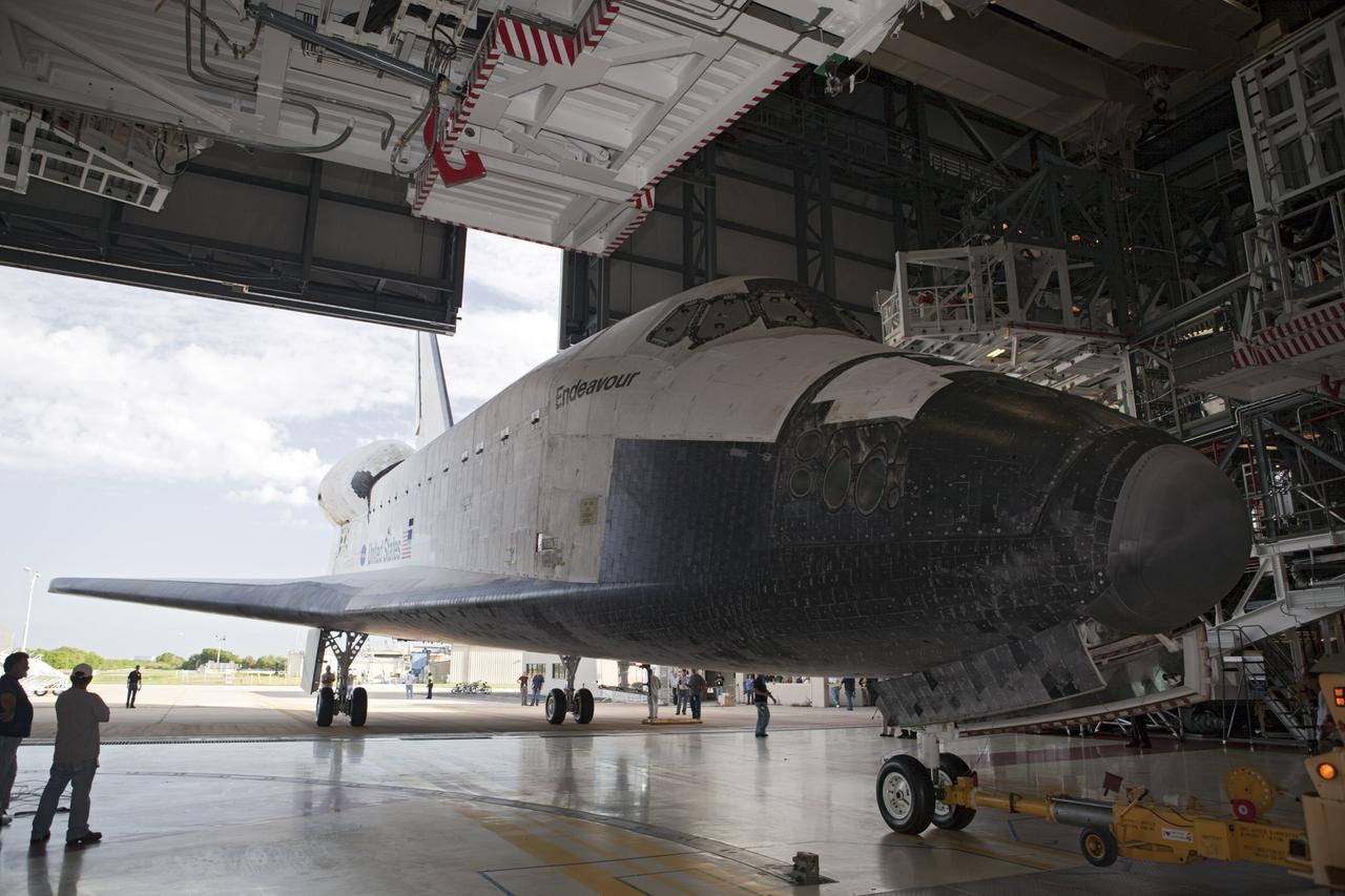 CAPE CANAVERAL, Fla. – The space shuttle Endeavour backs out of Bay 2 of the Orbiter Processing Facility at the Kennedy Space Center in Florida. Endeavour will be moved to the Vehicle Assembly Building to undergo final preparations for its cross-country ferry flight targeted for mid-September. The work is part of Transition and Retirement of the remaining space shuttles, Endeavour and Atlantis. Endeavour is being prepared for public display at the California Science Center in Los Angeles. Endeavour was the last space shuttle added to NASA’s orbiter fleet. Over the course of its 19-year career, Endeavour spent 299 days in space during 25 missions. For more information, visit http://www.nasa.gov/transition. Photo credit: NASA/Dimitri Gerondidakis
