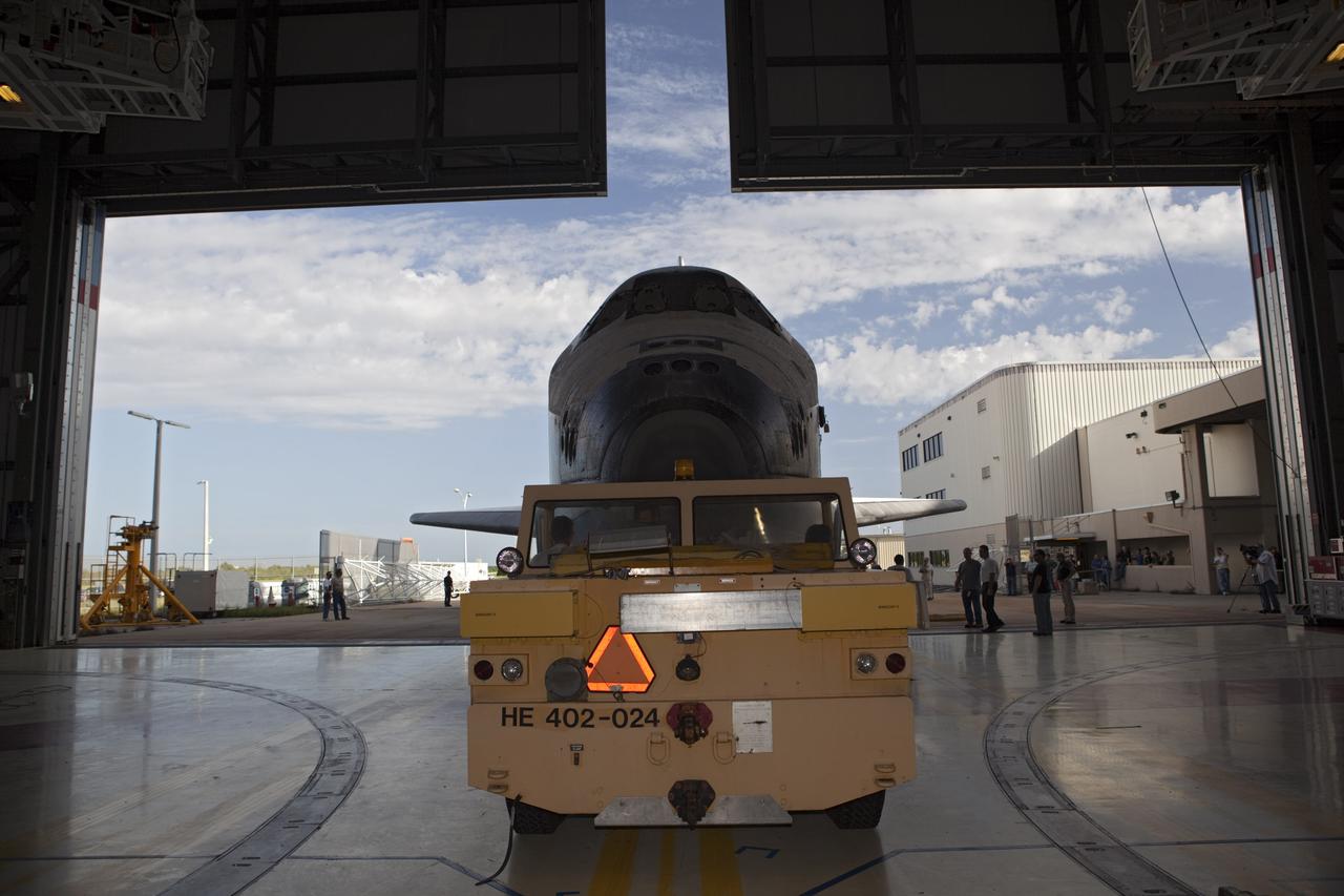 CAPE CANAVERAL, Fla. – A tow vehicle carefully backs the space shuttle Endeavour out of Bay 2 of the Orbiter Processing Facility at the Kennedy Space Center in Florida. Endeavour will be moved to the Vehicle Assembly Building to undergo final preparations for its cross-country ferry flight targeted for mid-September. The work is part of Transition and Retirement of the remaining space shuttles, Endeavour and Atlantis. Endeavour is being prepared for public display at the California Science Center in Los Angeles. Endeavour was the last space shuttle added to NASA’s orbiter fleet. Over the course of its 19-year career, Endeavour spent 299 days in space during 25 missions. For more information, visit http://www.nasa.gov/transition. Photo credit: NASA/Dimitri Gerondidakis