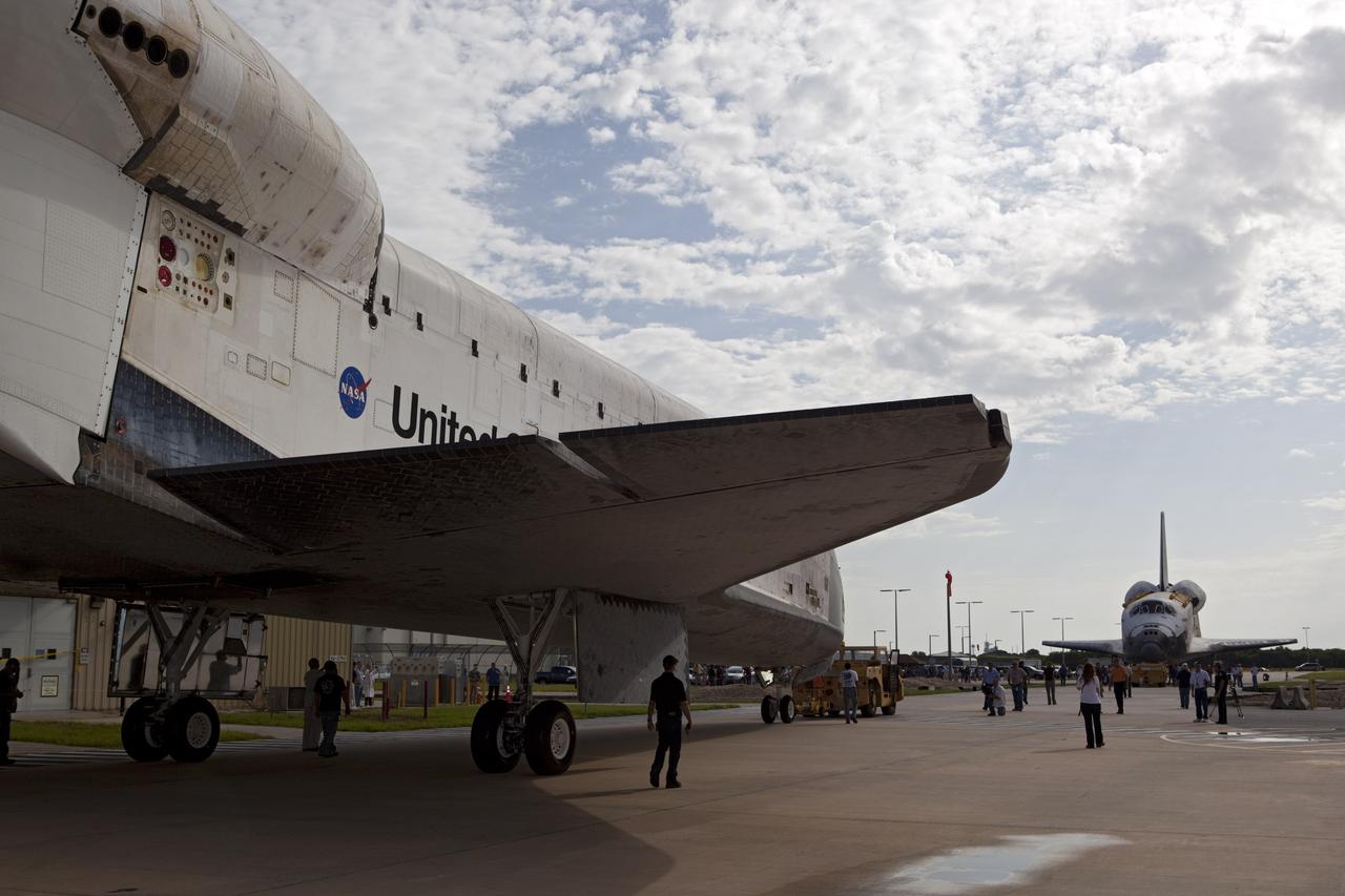The space shuttle Endeavour approaches sister shuttle Atlantis in the background for a brief photo opportunity at the Kennedy Space Center in Florida. Endeavour moved from Bay 2 of the Orbiter Processing Facility to switch places with Atlantis which had been in Vehicle Assembly Building VAB. In the VAB, Endeavour will undergo final preparations for its cross-country ferry flight targeted for mid-September. The work is part of Transition and Retirement of the remaining space shuttles, Endeavour and Atlantis. Endeavour is being prepared for public display at the California Science Center in Los Angeles. Endeavour was the last space shuttle added to NASA’s orbiter fleet. Over the course of its 19-year career, Endeavour spent 299 days in space during 25 missions. For more information, visit http://www.nasa.gov/transition. Photo credit: NASA/Dimitri Gerondidakis