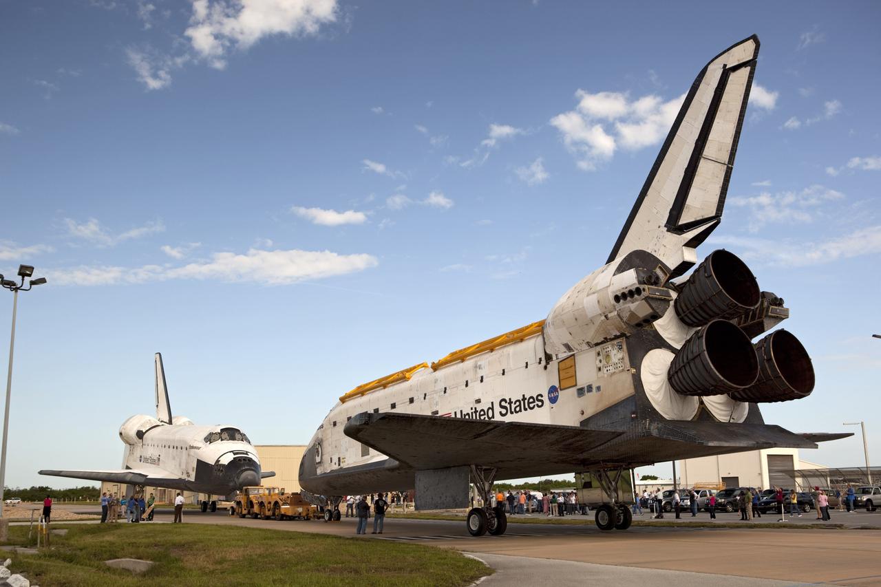 CAPE CANAVERAL, Fla. – The space shuttle Atlantis meets sister shuttle Endeavour in the background for a brief photo opportunity at the Kennedy Space Center in Florida. Endeavour moved from Bay 2 of the Orbiter Processing Facility to switch places with Atlantis which had been in Vehicle Assembly Building VAB. In the VAB, Endeavour will undergo final preparations for its cross-country ferry flight targeted for mid-September. The work is part of Transition and Retirement of the remaining space shuttles, Endeavour and Atlantis. Endeavour is being prepared for public display at the California Science Center in Los Angeles. Endeavour was the last space shuttle added to NASA’s orbiter fleet. Over the course of its 19-year career, Endeavour spent 299 days in space during 25 missions. For more information, visit http://www.nasa.gov/transition. Photo credit: NASA/Dimitri Gerondidakis