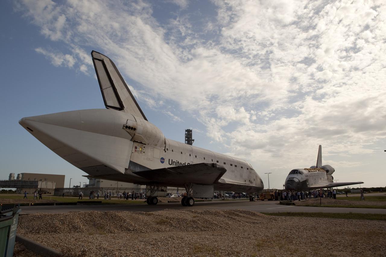 CAPE CANAVERAL, Fla. – The space shuttle Endeavour meets sister shuttle Atlantis, in the background, for a brief photo opportunity at the Kennedy Space Center in Florida. Endeavour moved from Bay 2 of the Orbiter Processing Facility to switch places with Atlantis which had been in Vehicle Assembly Building VAB. In the VAB, Endeavour will undergo final preparations for its cross-country ferry flight targeted for mid-September. The work is part of Transition and Retirement of the remaining space shuttles, Endeavour and Atlantis. Endeavour is being prepared for public display at the California Science Center in Los Angeles. Endeavour was the last space shuttle added to NASA’s orbiter fleet. Over the course of its 19-year career, Endeavour spent 299 days in space during 25 missions. For more information, visit http://www.nasa.gov/transition Photo credit: NASA/Dimitri Gerondidakis