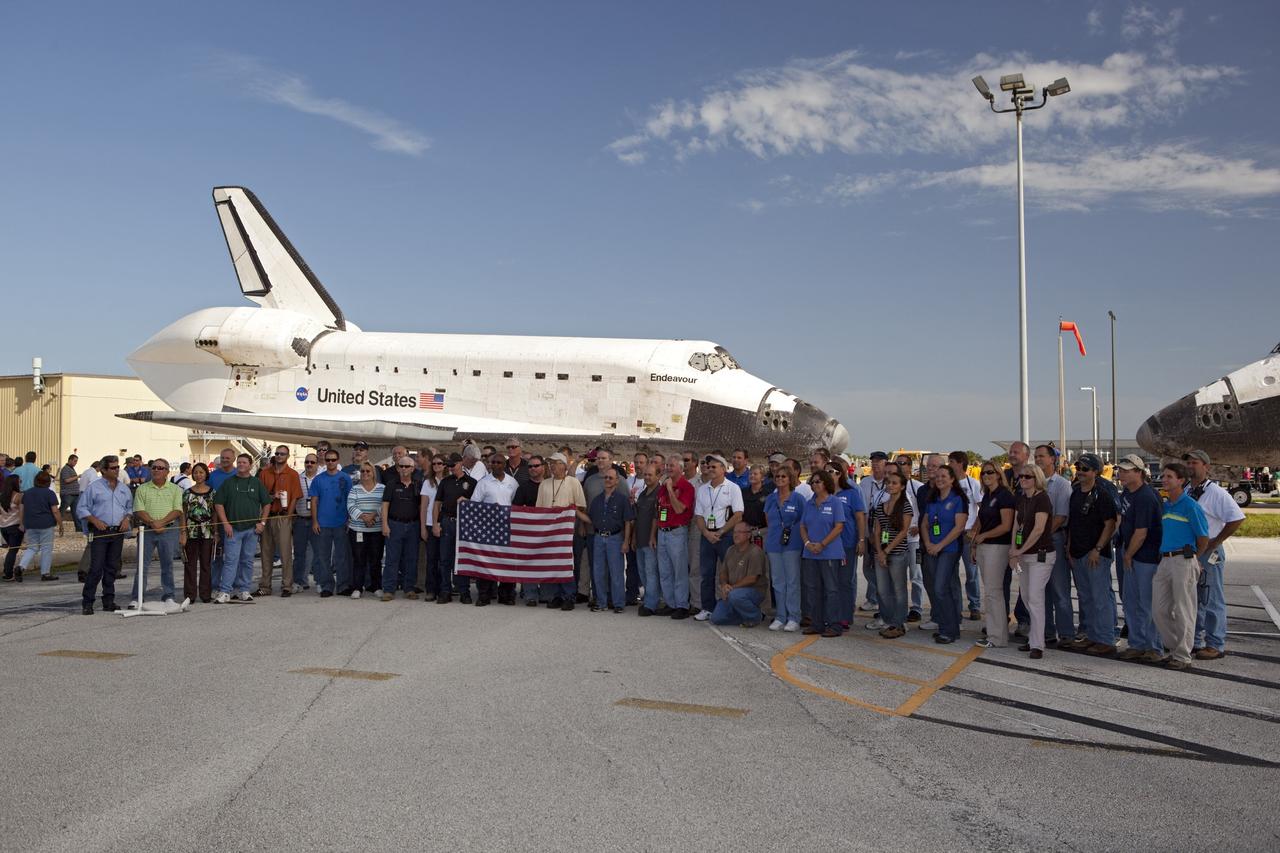 CAPE CANAVERAL, Fla. – Members of the Kennedy Space Center team that processed the space shuttle Endeavour gather for a group picture shortly after the spacecraft backed out of Bay 2 of the Orbiter Processing Facility. Endeavour switched places with Atlantis which had been in Vehicle Assembly Building, or VAB. In the VAB, Endeavour will undergo final preparations for its cross-country ferry flight targeted for mid-September. The work is part of Transition and Retirement of the remaining space shuttles, Endeavour and Atlantis. Endeavour is being prepared for public display at the California Science Center in Los Angeles. Endeavour was the last space shuttle added to NASA’s orbiter fleet. Over the course of its 19-year career, Endeavour spent 299 days in space during 25 missions. For more information, visit http://www.nasa.gov/transition Photo credit: NASA/Dimitri Gerondidakis