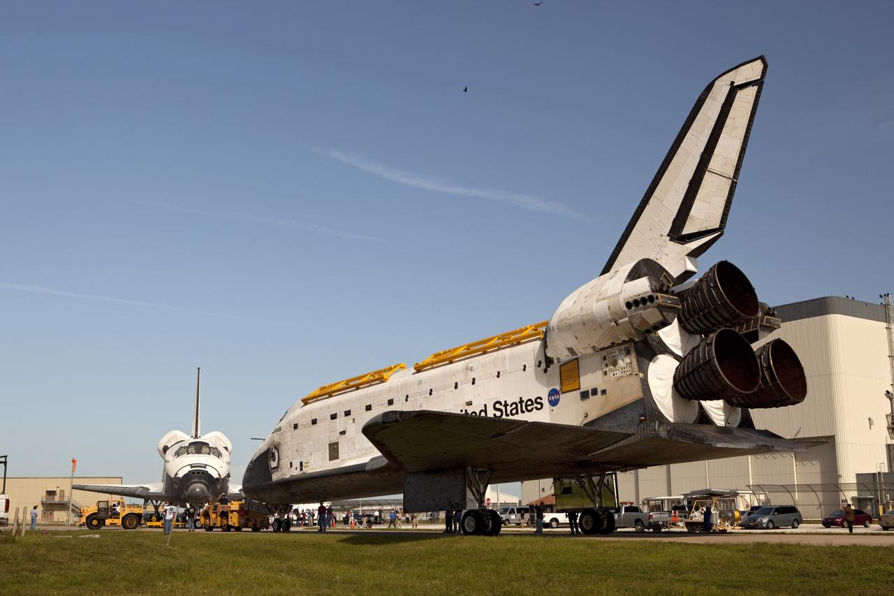 CAPE CANAVERAL, Fla. – The space shuttle Atlantis meets sister shuttle Endeavour in the background for a brief photo opportunity at the Kennedy Space Center in Florida. Endeavour moved from Bay 2 of the Orbiter Processing Facility to switch places with Atlantis which had been in Vehicle Assembly Building VAB. In the VAB, Endeavour will undergo final preparations for its cross-country ferry flight targeted for mid-September. The work is part of Transition and Retirement of the remaining space shuttles, Endeavour and Atlantis. Endeavour is being prepared for public display at the California Science Center in Los Angeles. Endeavour was the last space shuttle added to NASA’s orbiter fleet. Over the course of its 19-year career, Endeavour spent 299 days in space during 25 missions. For more information, visit http://www.nasa.gov/transition Photo credit: NASA/Dimitri Gerondidakis