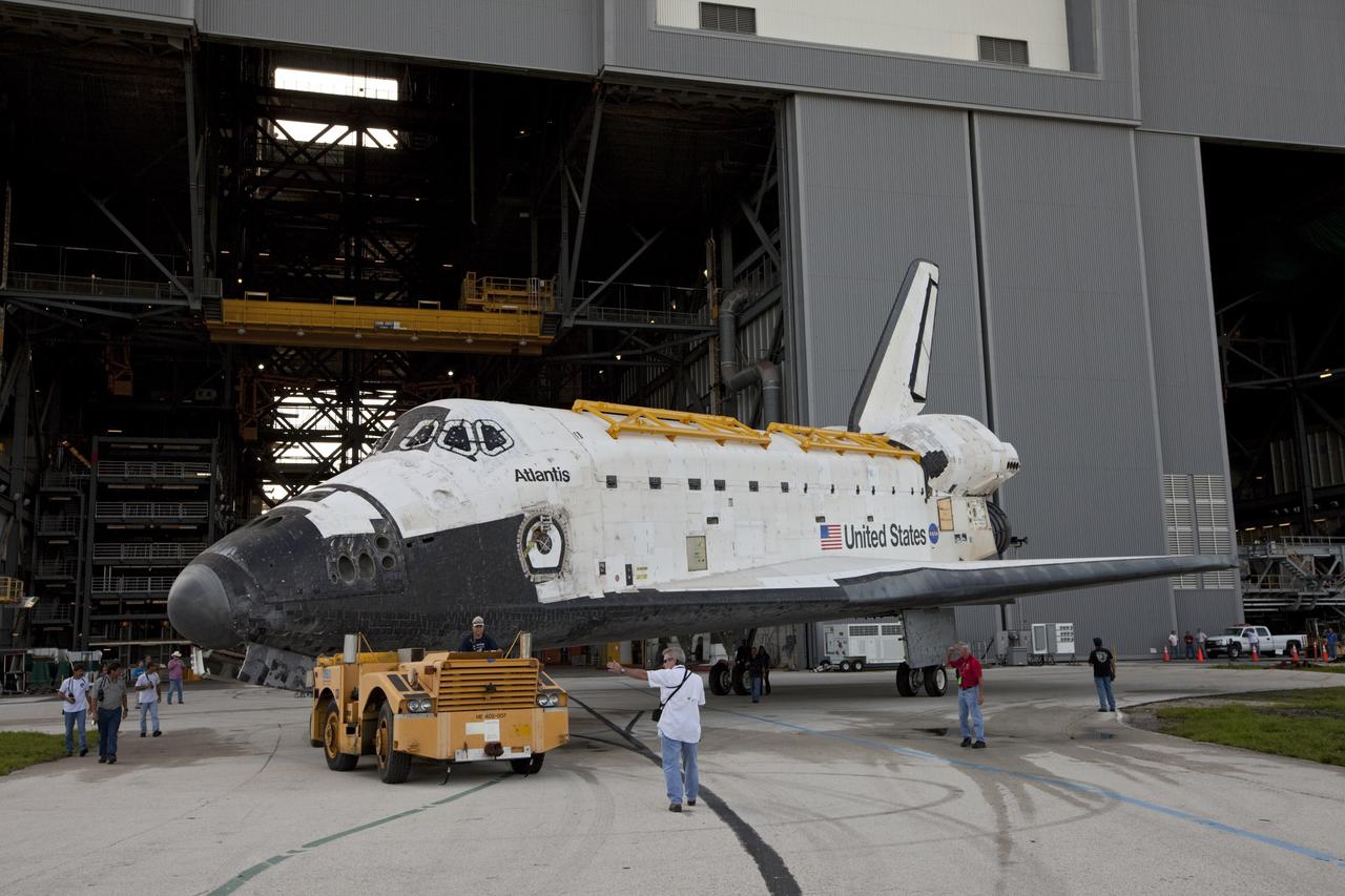 CAPE CANAVERAL, Fla. – United Space Alliance technicians monitor the space shuttle Atlantis as it moves out of the Vehicle Assembly Building at NASA's Kennedy Space Center in Florida. Atlantis is switching places with Endeavour which had been in Bay 2 of the Orbiter Processing Facility OPF. In the OPF, Atlantis will undergo final preparations for its transfer to the Kennedy Space Center Visitor Complex targeted for November. The work is part of Transition and Retirement of the remaining space shuttles, Atlantis and Endeavour. Atlantis is being prepared for public display at Kennedy's Visitor Complex. Over the course of its 26-year career, Atlantis spent 293 days in space during 33 missions. For more information, visit http://www.nasa.gov/transition Photo credit: NASA/Kim Shiflett