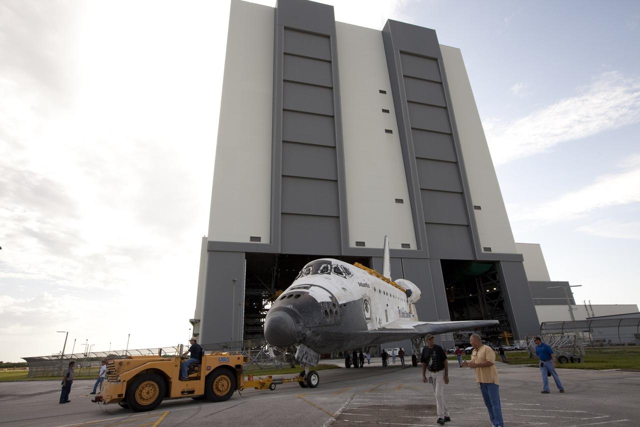 CAPE CANAVERAL, Fla. – The space shuttle Atlantis is towed away from the 525-foot-tall Vehicle Assembly Building at NASA's Kennedy Space Center in Florida. Atlantis is switching places with Endeavour which had been in Bay 2 of the Orbiter Processing Facility OPF. In the OPF, Atlantis will undergo final preparations for its transfer to the Kennedy Space Center Visitor Complex targeted for November. The work is part of Transition and Retirement of the remaining space shuttles, Atlantis and Endeavour. Atlantis is being prepared for public display at Kennedy's Visitor Complex. Over the course of its 26-year career, Atlantis spent 293 days in space during 33 missions. For more information, visit http://www.nasa.gov/transition Photo credit: NASA/Kim Shiflett