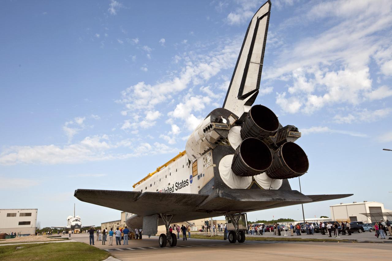 CAPE CANAVERAL, Fla. – The space shuttle Atlantis meets sister shuttle Endeavour in the background for a brief photo opportunity at NASA's Kennedy Space Center in Florida. Endeavour moved from Bay 2 of the Orbiter Processing Facility OPF to switch places with Atlantis which had been in Vehicle Assembly Building. In the OPF, Atlantis will undergo final preparations for its transfer to the Kennedy Space Center Visitor Complex targeted for November. The work is part of Transition and Retirement of the remaining space shuttles, Atlantis and Endeavour. Atlantis is being prepared for public display at Kennedy's Visitor Complex. Over the course of its 26-year career, Atlantis spent 293 days in space during 33 missions. For more information, visit http://www.nasa.gov/transition Photo credit: NASA/Kim Shiflett