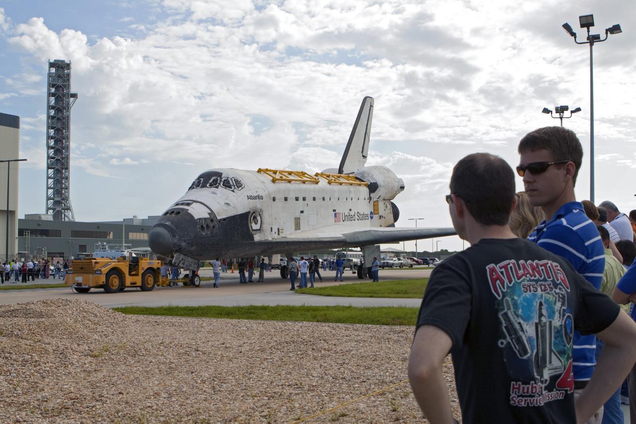 CAPE CANAVERAL, Fla. – Employees at NASA's Kennedy Space Center in Florida watch as the space shuttle Atlantis is towed from the Vehicle Assembly Building. Atlantis is switching places with Endeavour which had been in Bay 2 of the Orbiter Processing Facility OPF. In the OPF, Atlantis will undergo final preparations for its transfer to the Kennedy Space Center Visitor Complex targeted for November. The work is part of Transition and Retirement of the remaining space shuttles, Atlantis and Endeavour. Atlantis is being prepared for public display at Kennedy's Visitor Complex. Over the course of its 26-year career, Atlantis spent 293 days in space during 33 missions. For more information, visit http://www.nasa.gov/transition Photo credit: NASA/Kim Shiflett