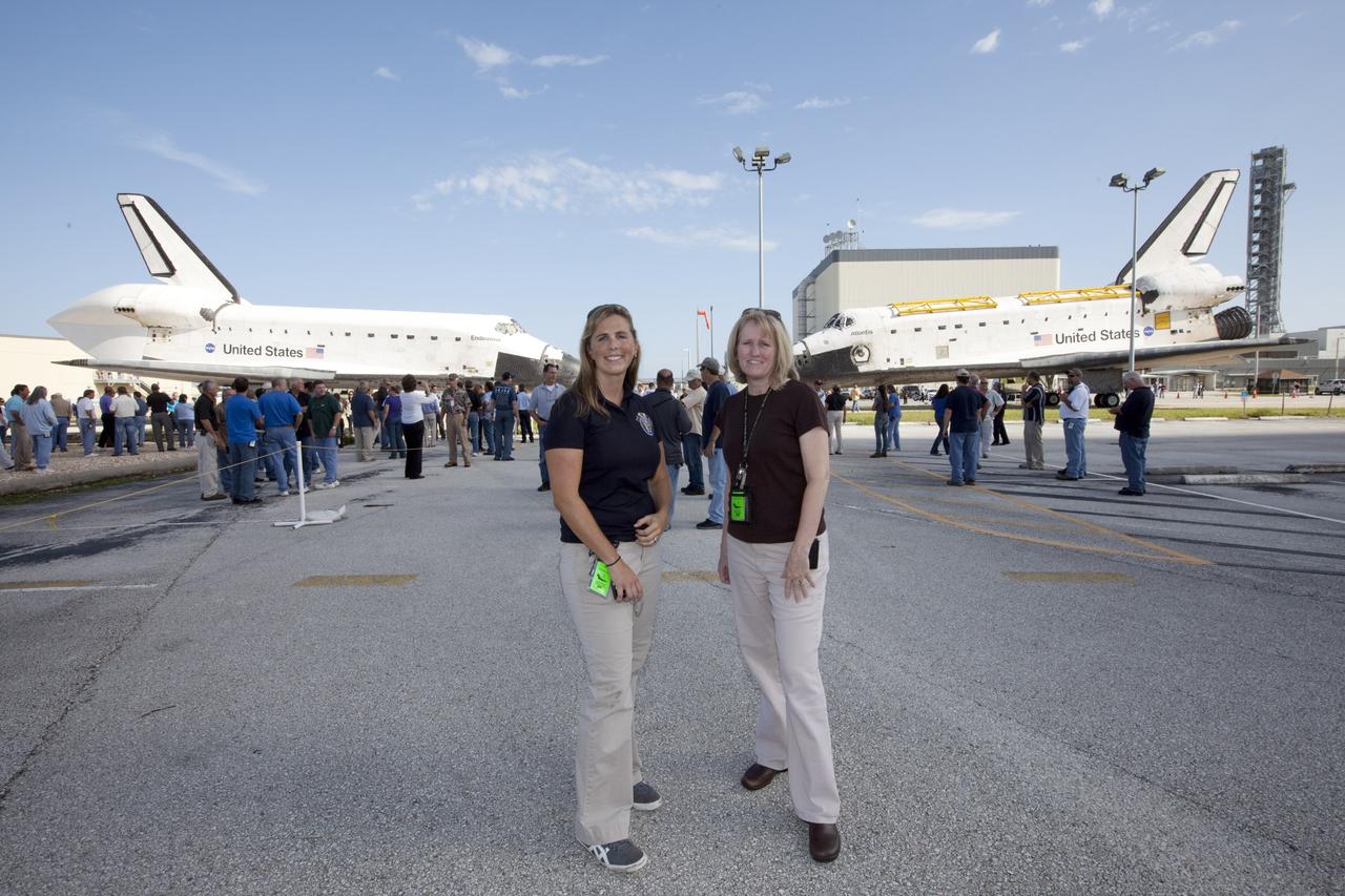 CAPE CANAVERAL, Fla. – Former NASA Endeavour flow director Dana Hutcherson, left, and former NASA Atlantis flow director Angie Brewer, pose with the two spacecraft that were brought together for a brief photo opportunity. Endeavour moved from Bay 2 of the Orbiter Processing Facility OPF to switch places with Atlantis which had been in Vehicle Assembly Building. In the OPF, Atlantis will undergo final preparations for its transfer to the Kennedy Space Center Visitor Complex targeted for November. The work is part of Transition and Retirement of the remaining space shuttles, Atlantis and Endeavour. Atlantis is being prepared for public display at Kennedy's Visitor Complex. Over the course of its 26-year career, Atlantis spent 293 days in space during 33 missions. For more information, visit http://www.nasa.gov/transition Photo credit: NASA/Kim Shiflett