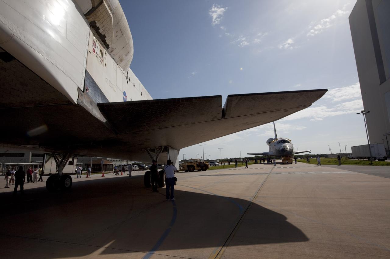 CAPE CANAVERAL, Fla. – The space shuttle Endeavour meets sister shuttle Atlantis in the background for a brief photo opportunity at the Kennedy Space Center in Florida. Endeavour moved from Bay 2 of the Orbiter Processing Facility OPF to switch places with Atlantis which had been in the Vehicle Assembly Building. In the OPF, Atlantis will undergo final preparations for its transfer to the Kennedy Space Center Visitor Complex targeted for November. The work is part of Transition and Retirement of the remaining space shuttles, Atlantis and Endeavour. Atlantis is being prepared for public display at Kennedy's Visitor Complex. Over the course of its 26-year career, Atlantis spent 293 days in space during 33 missions. For more information, visit http://www.nasa.gov/transition Photo credit: NASA/Kim Shiflett
