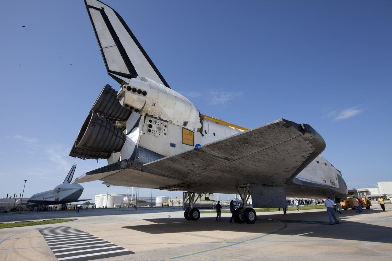 CAPE CANAVERAL, Fla. – The space shuttle Endeavour in the background moves away from sister shuttle Atlantis following a brief photo opportunity at the Kennedy Space Center in Florida. Endeavour moved from Bay 2 of the Orbiter Processing Facility OPF to switch places with Atlantis which had been in the Vehicle Assembly Building. In the OPF, Atlantis will undergo final preparations for its transfer to the Kennedy Space Center Visitor Complex targeted for November. The work is part of Transition and Retirement of the remaining space shuttles, Atlantis and Endeavour. Atlantis is being prepared for public display at Kennedy's Visitor Complex. Over the course of its 26-year career, Atlantis spent 293 days in space during 33 missions. For more information, visit http://www.nasa.gov/transition Photo credit: NASA/Kim Shiflett
