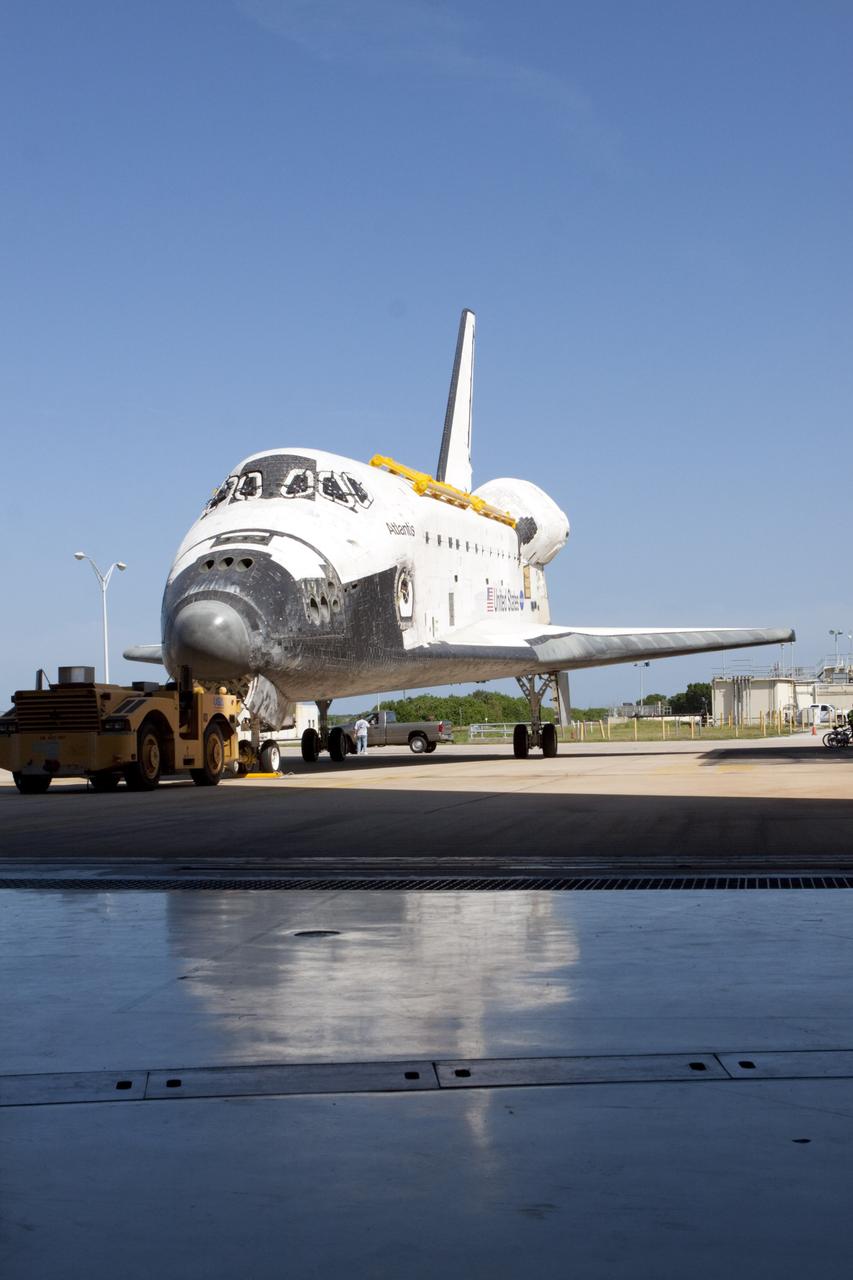 CAPE CANAVERAL, Fla. – The space shuttle Atlantis is towed into Bay 2 of the Orbiter Processing Facility OPF at NASA's Kennedy Space Center in Florida. Atlantis is switching places with Endeavour that moved into the Vehicle Assembly Building. In the OPF, Atlantis will undergo final preparations for its transfer to the Kennedy Space Center Visitor Complex targeted for November. The work is part of Transition and Retirement of the remaining space shuttles, Atlantis and Endeavour. Atlantis is being prepared for public display at Kennedy's Visitor Complex. Over the course of its 26-year career, Atlantis spent 293 days in space during 33 missions. For more information, visit http://www.nasa.gov/transition Photo credit: NASA/Kim Shiflett