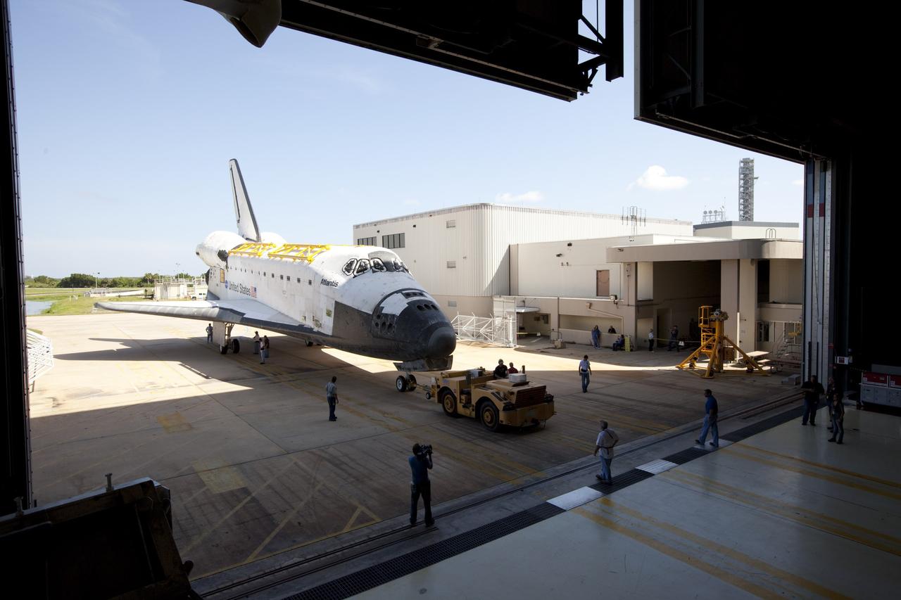 CAPE CANAVERAL, Fla. – The space shuttle Atlantis is towed into Bay 2 of the Orbiter Processing Facility OPF at NASA's Kennedy Space Center in Florida. Atlantis is switching places with Endeavour that moved into the Vehicle Assembly Building. In the OPF, Atlantis will undergo final preparations for its transfer to the Kennedy Space Center Visitor Complex targeted for November. The work is part of Transition and Retirement of the remaining space shuttles, Atlantis and Endeavour. Atlantis is being prepared for public display at Kennedy's Visitor Complex. Over the course of its 26-year career, Atlantis spent 293 days in space during 33 missions. For more information, visit http://www.nasa.gov/transition Photo credit: NASA/Kim Shiflett