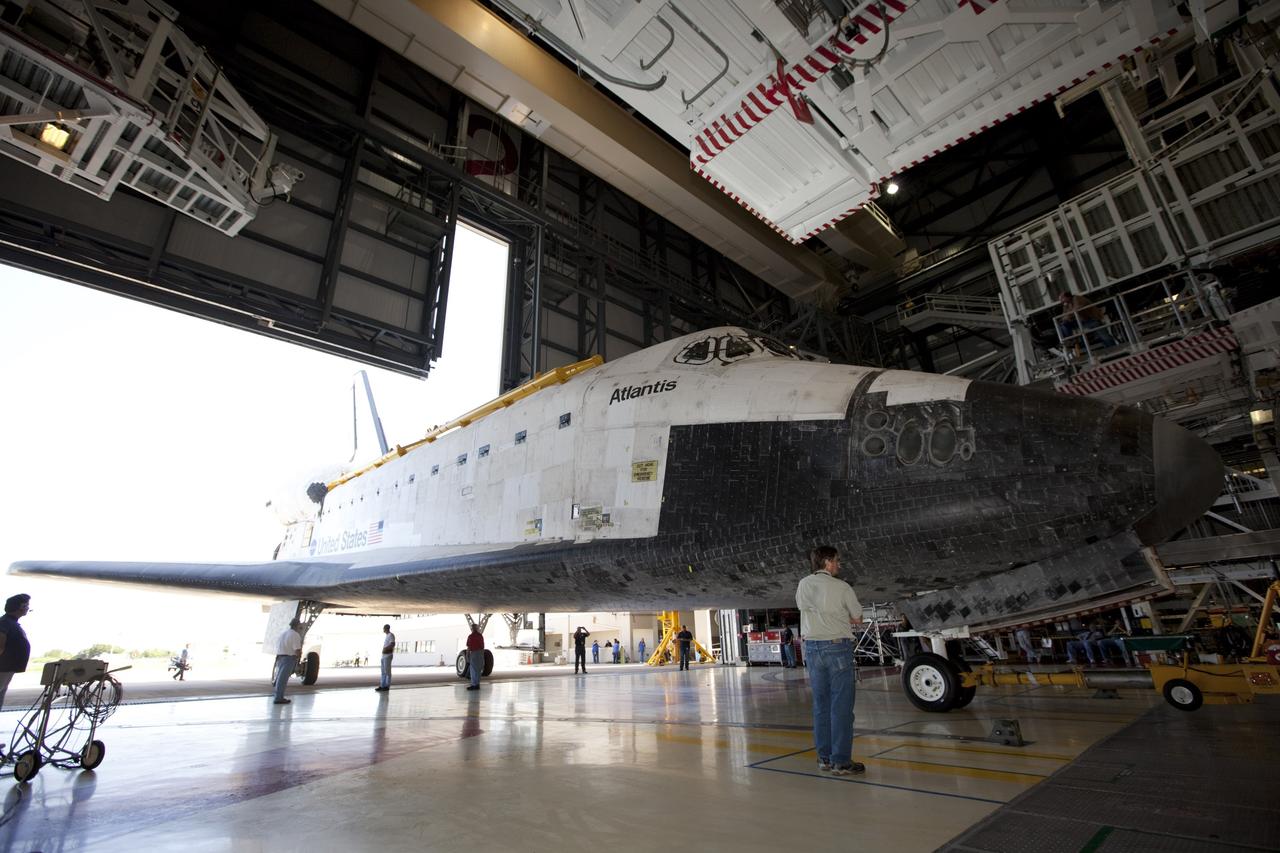 CAPE CANAVERAL, Fla. – Technicians monitor progress as the space shuttle Atlantis is towed into Bay 2 of the Orbiter Processing Facility OPF at NASA's Kennedy Space Center in Florida. Atlantis is switching places with Endeavour that moved into the Vehicle Assembly Building. In the OPF, Atlantis will undergo final preparations for its transfer to the Kennedy Space Center Visitor Complex targeted for November. The work is part of Transition and Retirement of the remaining space shuttles, Atlantis and Endeavour. Atlantis is being prepared for public display at Kennedy's Visitor Complex. Over the course of its 26-year career, Atlantis spent 293 days in space during 33 missions. For more information, visit http://www.nasa.gov/transition Photo credit: NASA/Kim Shiflett