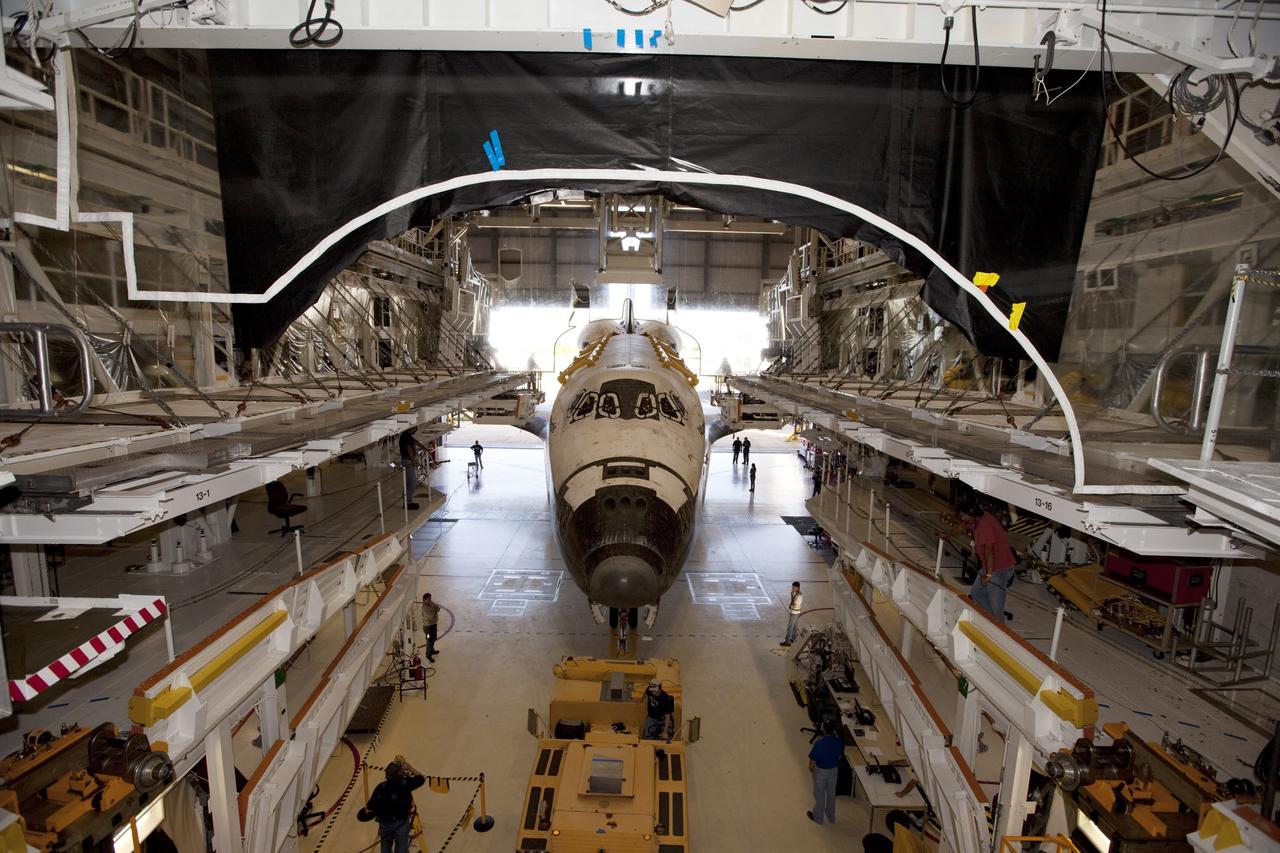 CAPE CANAVERAL, Fla. – This wide-angle view shows the space shuttle Atlantis as it enters Bay 2 of the Orbiter Processing Facility OPF at NASA's Kennedy Space Center in Florida. Atlantis is switching places with Endeavour that moved into the Vehicle Assembly Building. In the OPF, Atlantis will undergo final preparations for its transfer to the Kennedy Space Center Visitor Complex targeted for November. The work is part of Transition and Retirement of the remaining space shuttles, Atlantis and Endeavour. Atlantis is being prepared for public display at Kennedy's Visitor Complex. Over the course of its 26-year career, Atlantis spent 293 days in space during 33 missions. For more information, visit http://www.nasa.gov/transition Photo credit: NASA/Kim Shiflett