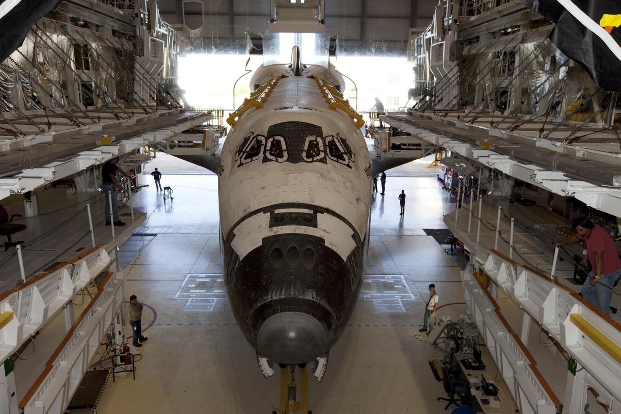 CAPE CANAVERAL, Fla. – This wide-angle view shows the space shuttle Atlantis as it enters Bay 2 of the Orbiter Processing Facility OPF at NASA's Kennedy Space Center in Florida. Atlantis is switching places with Endeavour that moved into the Vehicle Assembly Building. In the OPF, Atlantis will undergo final preparations for its transfer to the Kennedy Space Center Visitor Complex targeted for November. The work is part of Transition and Retirement of the remaining space shuttles, Atlantis and Endeavour. Atlantis is being prepared for public display at Kennedy's Visitor Complex. Over the course of its 26-year career, Atlantis spent 293 days in space during 33 missions. For more information, visit http://www.nasa.gov/transition Photo credit: NASA/Kim Shiflett