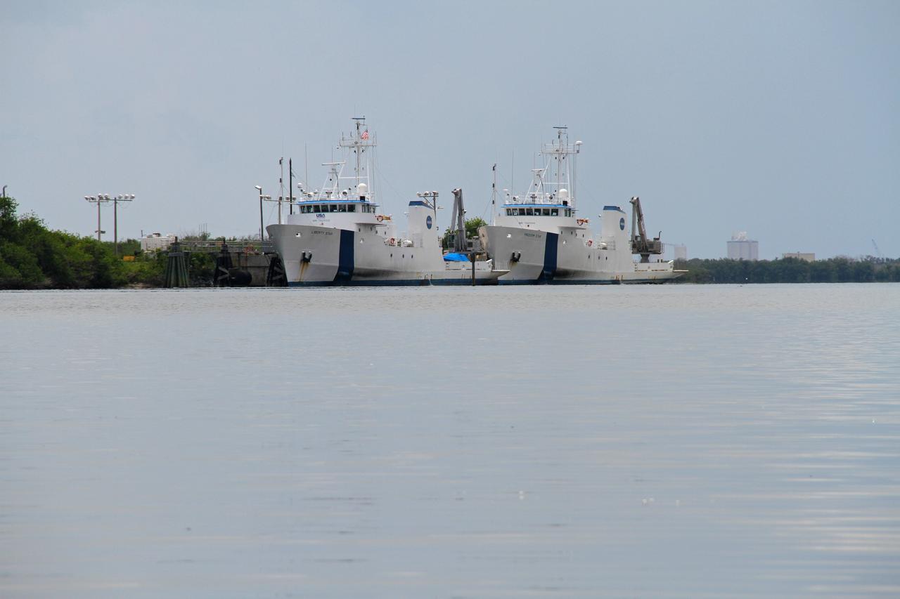 CAPE CANAVERAL, Fla. – The solid rocket booster SRB retrieval ships, Liberty Star and Freedom Star, are docked in the Banana River at Cape Canaveral Air Force Station's Hangar A F. The NASA vessels were used during the space shuttle era to retrieve the SRBs following shuttle launches. Kennedy is located on Merritt Island, a barrier island, about 34 miles long and varying in width from five to 10 miles. Only 6,000 acres are actually used for operational activities. The Kennedy Space Center is also a National Wildlife Refuge. Consisting of 140,000 acres, the refuge provides a wide variety of habitats: coastal dunes, saltwater estuaries and marshes, freshwater impoundments, scrub, pine flatwoods and hardwood hammocks providing habitat for more than 1,500 species of plants and animals. For more information, visit: http://ipv6.nasa.gov/centers/kennedy/shuttleoperations/alligators/kscovrv.html Photo credit: NASA/Ben Smegelsky