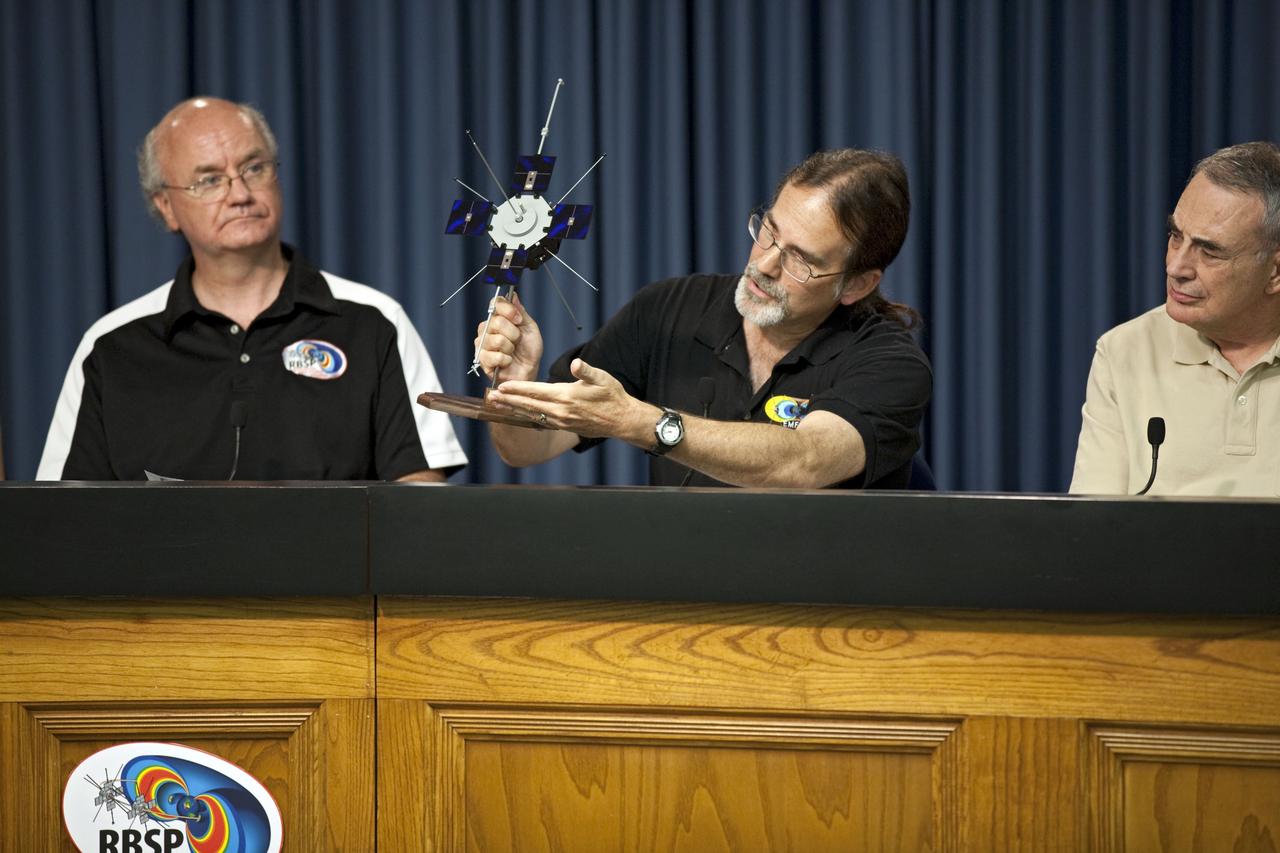 CAPE CANAVERAL, Fla. - During a mission science briefing for the Radiation Belt Storm Probes, or RBSP, mission at NASA Kennedy Space Center’s Press Site in Florida, Craig Kletzing, a principal investigator from the University of Iowa, answers questions and displays a scale model of the twin probes. To the left, is Harlan Spence, principal investigator with the University of New Hampshire. To the right, is Lou Lanzerotti, principal investigator with the New Jersey Institute of Technology.     NASA’s RBSP mission will help us understand the sun’s influence on Earth and near-Earth space by studying the Earth’s radiation belts on various scales of space and time. RBSP will begin its mission of exploration of Earth’s Van Allen radiation belts and the extremes of space weather after its launch aboard an Atlas V rocket. Launch is targeted for Aug. 24. For more information, visit http://www.nasa.gov/rbsp. Photo credit: NASA/Glenn Benson