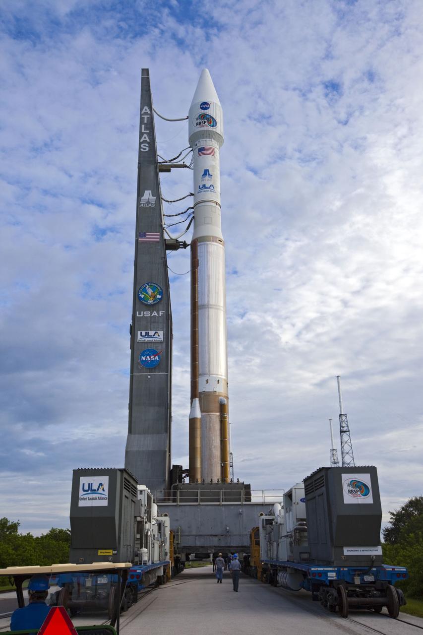 CAPE CANAVERAL, Fla. – Workers help guide the United Launch Alliance Atlas V rocket with the Radiation Belt Storm Probes, or RBSP, spacecraft aboard as it moves to the launch pad at Space Launch Complex 41 at Cape Canaveral Air Force Station. NASA’s RBSP mission will help researchers understand the sun’s influence on Earth and near-Earth space by studying the Earth’s radiation belts on various scales of space and time. RBSP will begin its mission of exploration of Earth’s Van Allen radiation belts and the extremes of space weather after its launch aboard an Atlas V rocket. Launch is targeted for Aug. 24. Photo credit: NASA/Kim Shiflett