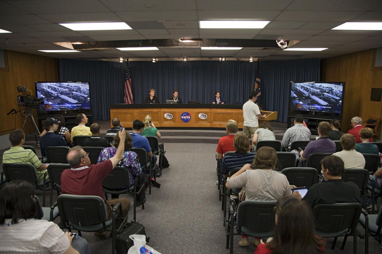 CAPE CANAVERAL, Fla. -- At NASA's Kennedy Space Center in Florida, social media participants take part in a question and answer session with astronauts aboard the International Space Station. At the podium, Ranz Adams asks a question of space station flight engineer Joe Acaba. Leading the activity from the desk at the front of the room are, from the left, Laurel Lichtenberger of NASA Public Affairs, Jason Townsend of the NASA Social Media Team and Kerri Beisser of the Johns Hopkins University Applied Physics Laboratory.      The social media gathering at the Florida spaceport took place Aug. 22, 2012 joining a world-wide NASA Social allowing participants to ask questions of NASA astronauts who are living and working aboard the International Space Station. . For more information, visit http://www.nasa.gov/mission_pages/station/main/index.html Photo credit: NASA/ Frankie Martin