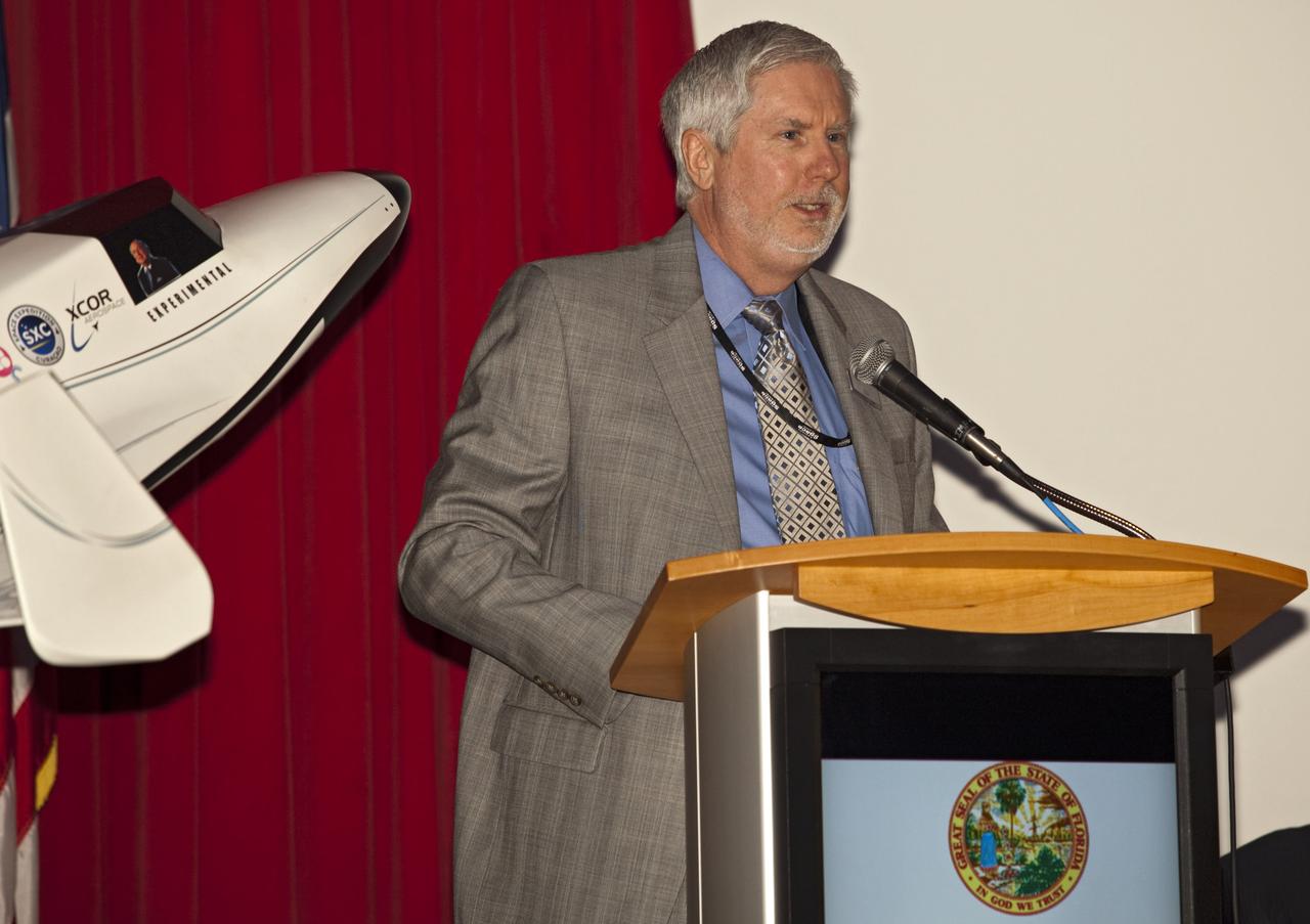 CAPE CANAVERAL, Fla. - At NASA's Kennedy Space Center in Florida, Bill Moore, chief operating officer of the Kennedy Space Center Visitor Complex, addresses guests at a presentation during which XCOR Aerospace announced plans to open a manufacturing operation in Brevard County.    The company's suborbital Lynx Mark II spacecraft possibly will take off and land at Kennedy's shuttle landing facility. XCOR Aerospace is a small, privately held California corporation with focus on the research, development, project management and production of reusable launch vehicles, rocket engines and rocket propulsion systems. XCOR will focus on space tourism, experimental flights and launching satellites. Photo credit: NASA/ Frankie Martin